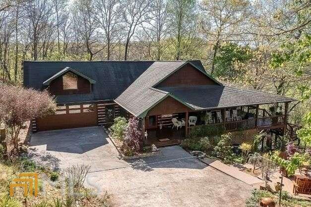 RARE OFFERING. Magnificent 3,600sf pristine home with many custom features on 3 acres w/245 ft of frontage on clear running, stocked trout stream. Relax to the sounds of rippling water on your waterside deck or launch your canoe or tube. Walk out of the spacious great room onto a giant deck customized for year-round living. Lovely landscaping with several seating areas. Huge lower-level family room perfect for entertaining all ages w/full size bar, pool table, fireplace, custom porch w/hot tub & lounge area. 9COx11CO workshop w/8ft worktable, pegboards & shelves. 2 miles to the great new Old Toccoa Farms golf course. 9 miles to shops and restaurants in Blue Ridge. Buyer can purchase adjoining 3.6 ac creekfront lot at a big discount.
