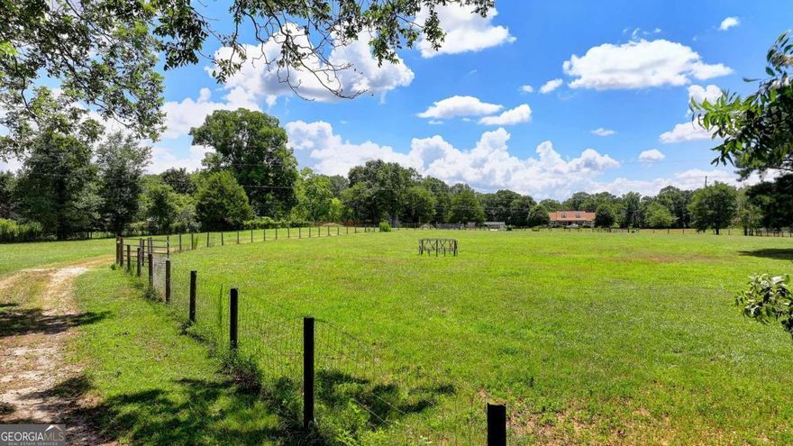 Charming 4-sides brick home on 15.9 acres with 4 bedrooms and 3 bathrooms. Features 508 ft of frontage plus an additional 114 ft of access. Fully fenced and currently operating as a cattle and horse farm. Level land with a stream, small pond, and creek at the back of the property. Includes 2 barns. Excellent location and an excellent opportunity for farm living with modern comfort.