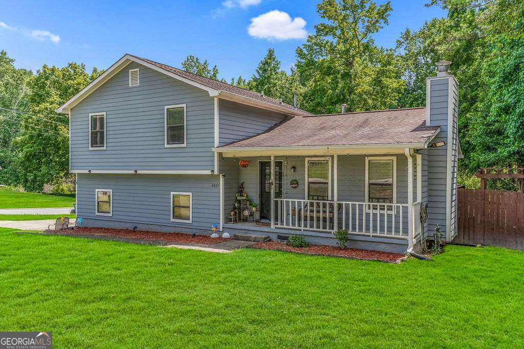 Welcome to this charming 4 BR, 2.5 BA multi-split home perfectly positioned on a corner lot in an HOA-free neighborhood in the heart of Snellville-step inside from the inviting covered front porch into a bright living room filled with natural light and anchored by a cozy fireplace that opens to the dining area and the well-maintained kitchen, boasting granite countertops, elegant cabinetry, a sophisticated custom tile backsplash, and stainless steel appliances. From the dining area, enjoy direct access to an expansive deck perfect for entertaining and overlooking the fully fenced backyard. Upstairs, a tranquil primary suite with an updated bath featuring a granite-top vanity and shower-tub combo, plus two additional bedrooms and an updated full bath. The lower level includes a spacious 4th bedroom-ideal for guests, home office, or flex space-an updated half bath with laundry, easy backyard access, and an attached one-car garage. Durable hard-surface flooring throughout-no carpet. All kitchen appliances, washer, and dryer stay. Just minutes from shopping, dining, and amenities-come see why this is the perfect place to call home!