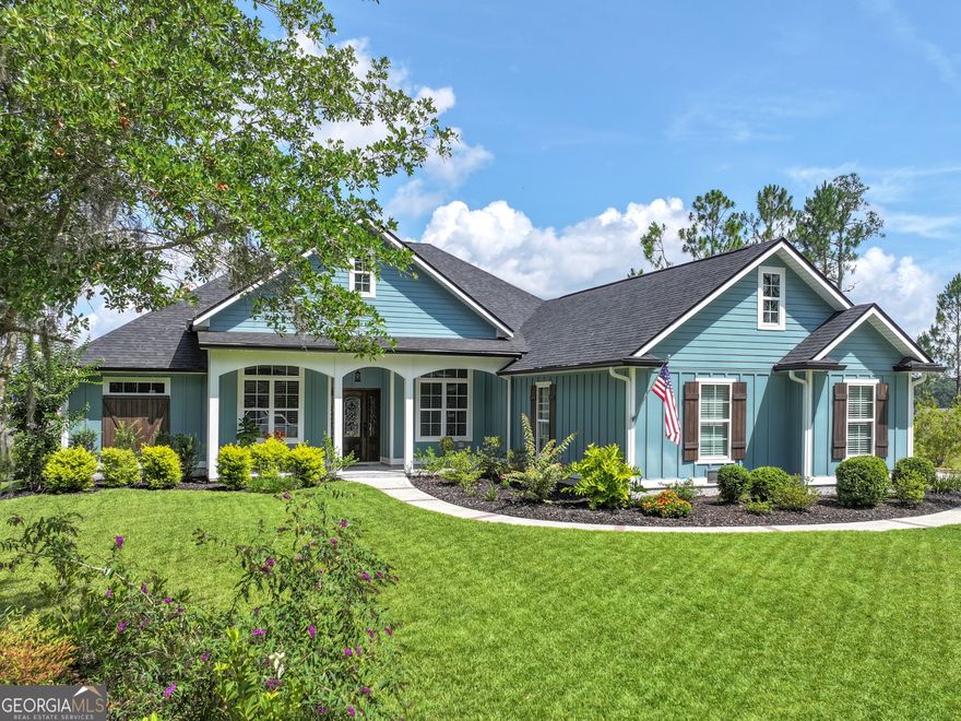 THIS STUNNING FOUR-BEDROOM, THREE-AND-A-HALF-BATH CUSTOM HOME IS PERFECTLY POSITIONED ON AN EXPANSIVE ESTATE LOT WITH SWEEPING MARSH AND WATER VIEWS.  BUILT IN 2022 WITH DURABLE, LOW-MAINTENANCE CONCRETE SIDING, THE HOME OFFERS EXCEPTIONAL OUTDOOR LIVING, INCLUDING A BEAUTIFULLY LANDSCAPED YARD WITH A PRIVATE WELL-POWERED IRRIGATION SYSTEM AND A WALKWAY CONNECTING THE DRIVEWAY TO THE BACKYARD.  THE SCREENED LANAI IS IDEAL FOR RELAXING OR ENTERTAINING, FEATURING TILE FLOORING, A DEEP SINK, AND PLUMBING ALREADY IN PLACE FOR YOUR FUTURE OUTDOOR KITCHEN.  INSIDE, THE HOME SHOWCASES ELEGANT SPANISH PORCELAIN TILE THROUGHOUT AND A BRIGHT, OPEN LIVING SPACE WITH A COFFERED CEILING AND ABUNDANT NATURAL LIGHT. THE KITCHEN IS A CHEF'S DREAM, EQUIPPED WITH A GAS COOKTOP, WALK-IN PANTRY, AMPLE PREP SPACE, AND A LARGE ISLAND WITH SEATING, COMPLEMENTED BY AN EAT-IN DINING AREA.  A FORMAL DINING ROOM PROVIDES ADDITIONAL SPACE FOR ENTERTAINING OR COULD BE REPURPOSED AS NEEDED.  JUST OFF THE FOYER, THE FOURTH BEDROOM IS CURRENTLY USED AS A HOME OFFICE, OFFERING FLEXIBILITY TO SUIT YOUR LIFESTYLE.  THE SPACIOUS PRIMARY SUITE OFFERS PRIVATE ACCESS TO THE LANAI, DUAL WALK-IN CLOSETS, AND A LUXURIOUS EN SUITE BATH WITH SEPARATE VANITIES AND AN OVERSIZED WALK-IN SHOWER.  TWO ADDITIONAL BEDROOMS EACH FEATURE THEIR OWN PRIVATE BATHROOMS IN A DESIRABLE SPLIT FLOOR PLAN LAYOUT.  ADDITIONAL FEATURES INCLUDE AN INDOOR LAUNDRY ROOM, A THREE-CAR GARAGE WITH A SEPARATE STORAGE ROOM, TWO GAS TANKLESS WATER HEATERS, A SMART THERMOSTAT, AND LEAFFILTER GUTTER GUARDS.  A WOODEN SEAWALL ADDS AN EXTRA LAYER OF PROTECTION FOR THE PROPERTY.  LOCATED IN STUNNING WINDING RIVER COMMUNITY, RESIDENTS ENJOY ACCESS TO A POOL, FITNESS CENTER, CLUBHOUSE, SPORTS FIELD, AND WALKING/BIKING TRAILS.  THIS HOME IS CONVENIENTLY SITUATED NEAR SCHOOLS, SHOPPING, DINING, AND I-95, AND JUST MINUTES FROM KINGS BAY NAVAL SUBMARINE BASE.