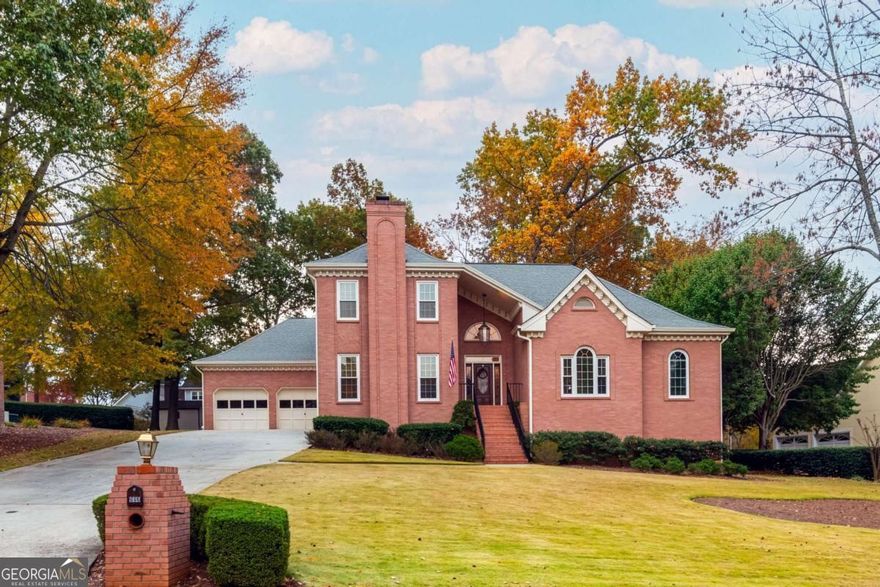 A refreshed all-brick classic in one of Lawrenceville's most character-filled neighborhoods. Tucked inside Cramac Plantation, an established enclave with an optional HOA just minutes from downtown Lawrenceville, this home is a breath of fresh air in a sea of cookie cutter communities. Every house here has a story, and this one's been thoughtfully renewed for its next chapter. Inside, fresh paint throughout and newly installed tile floors in the kitchen and laundry room give the home a crisp, updated feel without losing its timeless charm. The main level opens to elegant living and dining spaces anchored by a gas fireplace, while the vaulted eat-in kitchen offers new appliances (including a new ceramic convection cooktop, convection wall oven, wall microwave, and dishwasher), real wood cabinets, generous counter space, and a bright breakfast area that overlooks a cozy fireside den with beautiful natural wood built-ins and a second fireplace; the den is easily everyone's favorite room in the house. The spacious primary suite on the main level feels like a true retreat, complete with a private sitting room, screened porch, dual closets, and a spa-inspired bath with a jetted tub, a large walk-in shower, and dual vanities. Upstairs you'll find three spacious bedrooms, a full bath, and a large floored attic perfect for future expansion or easy storage. Downstairs, the daylight finished basement provides incredible flexibility, featuring a wet bar, media and game areas, plenty of room for a home gym and so much more, plus an expansive unfinished section ideal for storage or a workshop. Step outside to a large low-maintenance Trex deck, perfect for grilling, entertaining, or relaxing in the hot tub surrounded by mature trees. Additional storage can be found under the deck. The mostly level backyard is private, shaded, and ready for gatherings, playtime, or a quiet morning coffee. With newer HVAC systems, upgraded windows, a new front door on order, and easy access to downtown Lawrenceville's shops, restaurants, and events, this home delivers both comfort and character, a rare combination. In a neighborhood that values individuality, this is where lasting memories are made.
