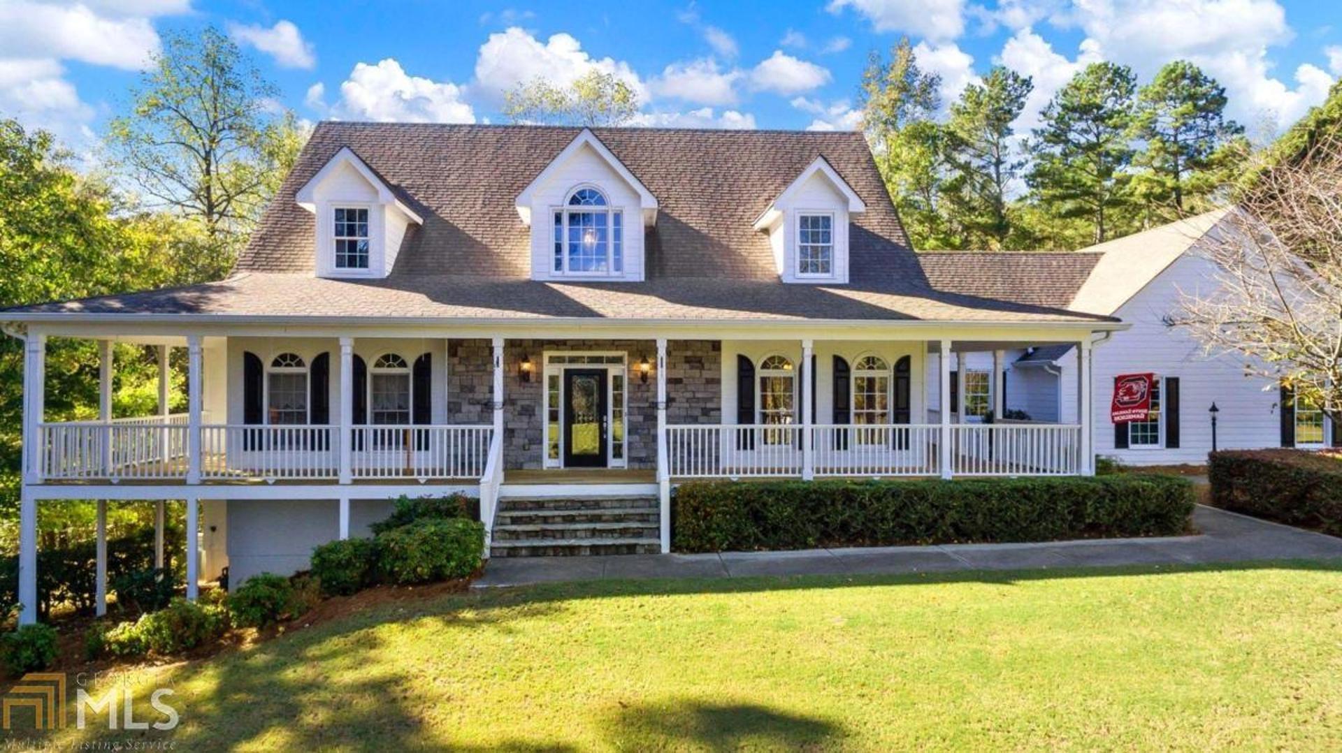BEAUTIFUL SOUTHERN LIVING STYLE HOME SITTING ON 15+ PRIVATE ACRES IN BUFORD/FLOWERY BRANCH. FAST GROWING AREA OFF OF FRIENDSHIP ROAD! ENJOY ROCKING CHAIR FRONT PORCH AND WRAP AROUND SIDE PORCH. OPEN FLOOR PLAN W/ CHEFS KITCHEN AND DOUBLE SIDED STONE FIREPLACE THAT OPENS TO 2 STORY GREAT RM FOR ENTERTAINING. MASTER ON MAIN W/ TOTALLY *REMODELED SPA BATHRM. GUEST RM WITH PRIVATE BATH ON MAIN. X-LARGE *REMODELED MUDROOM AND TONS OF CABINETS FOR STORAGE. TWO LARGE SECONDARY BEDRMS UPSTAIRS WITH THEIR OWN PRIVATE BATHRMS. *NEW HVAC* NEW DESIGNER PAINT*FINISHED TERRACE LEVEL W/ BEDROOM, BATHROOM, KITCHEN, PERSONAL GYM, GAME ROOM, FAMILY ROOM, AND A BEAUTIFUL STONE FIREPLACE. TONS OF HARDWOODS AND TILE THRU-OUT. THREE CAR GARAGE. ENTER PROPERTY THROUGH PRIVATE GATE AND CROSS OVER COVERED BRIDGE AS YOU MAKE YOUR WAY DOWN THE LONG DRIVEWAY TO THIS CUSTOM BUILT HOME. LOVINGLY MAINTAINED! SOUGHT AFTER AREA! CALL TO SCHEDULE AN EASY SHOWING.