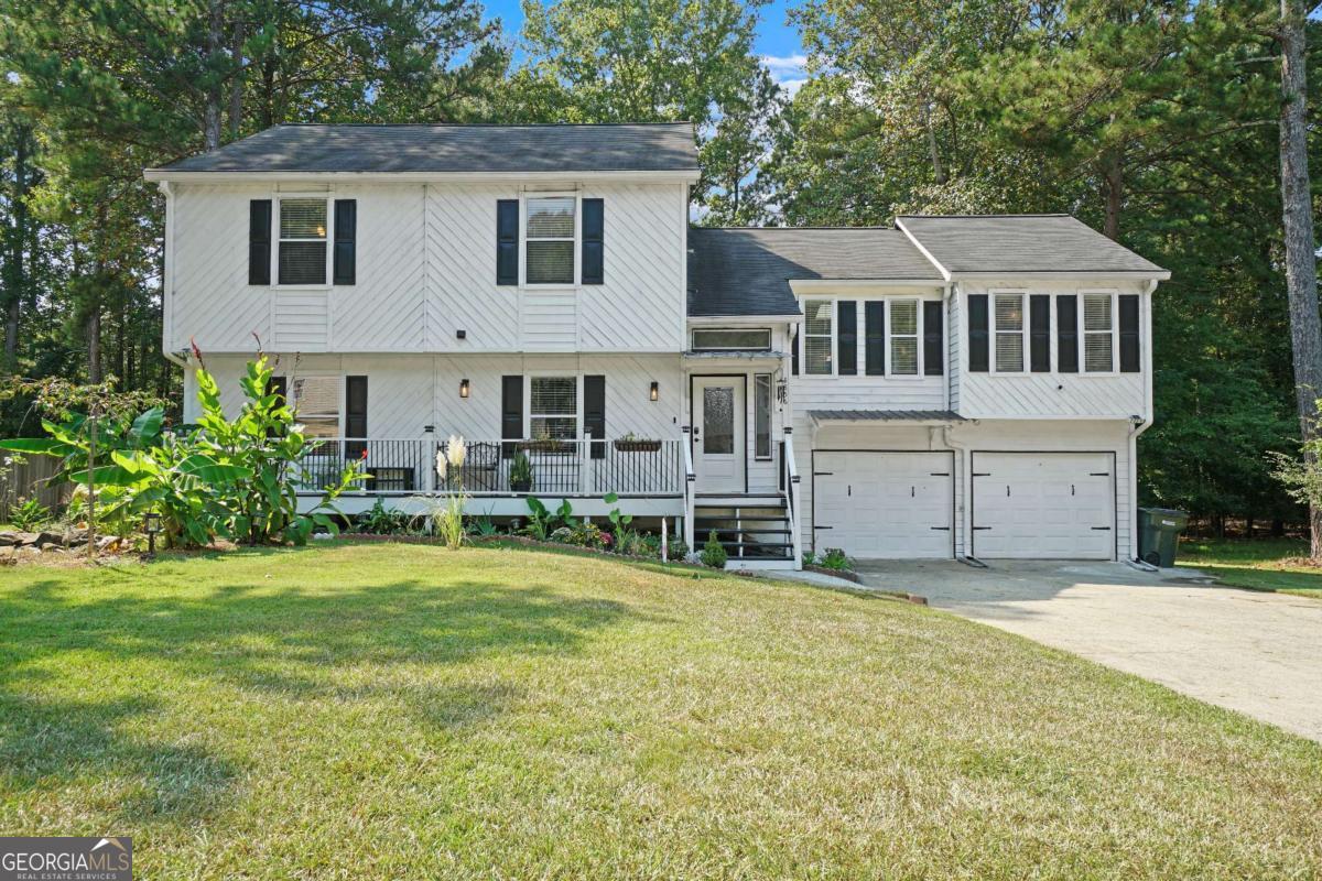 Welcome home to this beautifully updated and truly move-in ready 4-bedroom, 2.5-bath retreat in the heart of Kennesaw. Nestled in a quiet community with no HOA, this home has been thoughtfully upgraded to blend charm, comfort, and modern living. The curb appeal is undeniable. Lush landscaping frames the home, leading you to the rocking chair front porch-recently added by the seller and stretching across the front, a rare feature in this neighborhood. It's the perfect place to enjoy your morning coffee while listening to the gentle sounds of the custom waterfall feature, setting a tone of peace and relaxation before you even step inside. Just beyond the front door, the expansive living room welcomes you in. Vaulted ceilings and skylights fill the space with natural light, while newly added recessed lighting ensures a warm, inviting glow at any time of day. This spacious room offers endless possibilities-whether you're hosting friends for game night, enjoying quiet evenings by the cozy fireplace, or gathering with family, it's a space designed to bring people together and make lasting memories. The kitchen is a true centerpiece, blending style and function with ease. Crisp white cabinetry complements the timeless Corian countertops and tile backsplash, while the new farmhouse-style stainless steel sink adds both charm and practicality. Completing the space, all appliances are stainless steel, highlighted by an upgraded vent hood. Spacious and open, the kitchen flows effortlessly between the living and dining areas, making entertaining and everyday life a breeze. Just a few steps up from the living room, you'll find the oversized primary suite, offering his-and-hers closets, a spa-like ensuite with double vanities and brand-new granite counters, and a soaking tub to unwind after a long day. Two large secondary bedrooms are also on this level, each with walk-in closets of their own. The hall bath shines with an upgraded vanity topped with marble and natural light from its skylight. The lower level provides incredible flexibility with a sprawling fourth bedroom-ideal as a guest suite, media room, or multi-generational living space. With its own half bath and private deck, it feels like a retreat all its own. Out back, the level yard is designed for connection and fun. The newly rebuilt deck and addition of the retractable awning (2022) creates the perfect space for dining al fresco, while the firepit area below invites evenings gathered with friends and family under the stars. Located in the sought-after Cobb County School District, this home is just minutes from Swift-Cantrell Park, Kennesaw Mountain, Kennesaw Marketplace, and vibrant Downtown Kennesaw. Easy access to US 41 and I-75 makes commuting effortless. This isn't just a house-it's a home where every space was designed for living, gathering, and creating lasting memories. Schedule your private showing today!