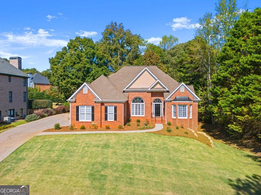 RECENTLY RENOVATED RANCH ON BASEMENT IN SOUGHT AFTER SWIM TENNIS/ PICKLEBALL COMMUNITY WITH LOWER FORSYTH TAXES! We completely renovated this custom built ranch so there is nothing left for you to do. Each room highlights today's trend right design in a neutral palette, warm and appealing.The vaulted family room is stunning with a two tiered brushed gold chandelier and newly resurfaced stone fireplace with gas logs for ease of use. The kitchen is one you'll be proud to entertain in with new cabinet doors in creamy white, Quartz counters and new backsplash. The gold cabinet hardware is high quality, Top Knobs brand. New cooktop and microwave. New deep stainless sink and gold faucet. You'll see the gold lighting carried throughout the home. The primary and secondary bath were completely remodeled with new vanities, decorator tile, toilets, lighting and fixtures. The primary bath has a large shower with frameless shower door and freestanding tub. The main floor also boast two secondary bedrooms with adjoining bath, powder room, large dining room and home office, both with 11' ceilings. The entire home was painted a decorator white. Site finished hardwoods were added to the primary bedroom and dining room and all were refinished. The terrace level is partially finished with drywall, electrical, lighting and a new HVAC. Just add the flooring of your choice. Walk out from main level to a newly stained deck with low staircase to backyard- much easier on kids and our 4 legged friends. This is a home you'll be proud of in a community you'll never leave. Welcoming neighbors, active swim tennis and incredible schools and location. Easy access to GA 400, The Collection Mall, Halcyon, Cumming City Center and more. You are in the heart of it all! Welcome home.