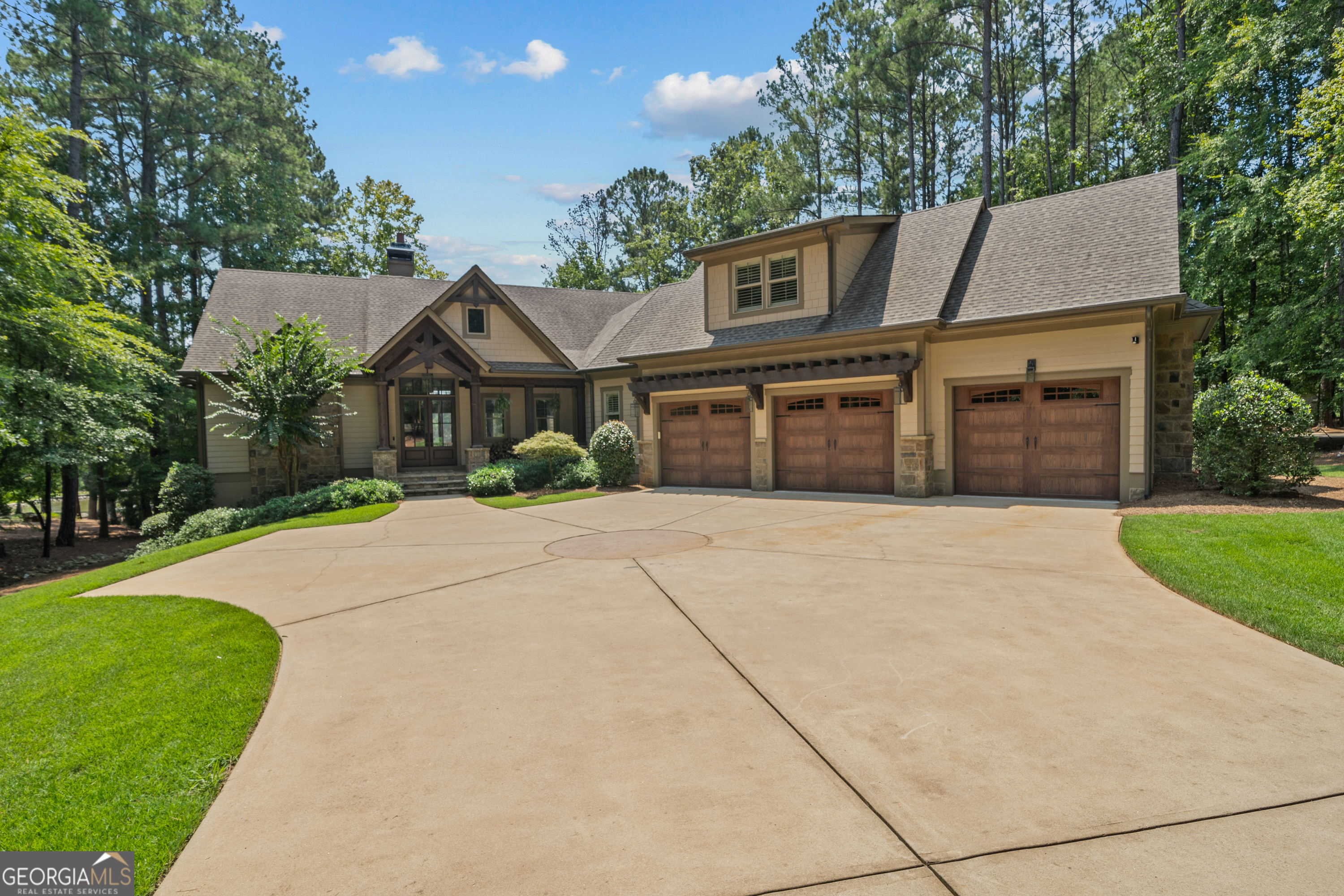 BEST VALUE LAKEFRONT HOME IN REYNOLDS LAKE OCONEE !! This luxurious craftsman-style home is in a highly desirable location within minutes to the Lake Club and Ritz Carlton. A recently renovated masterpiece by Windsor Homes, featuring exquisite custom decor by Black Sheep Interiors. This home has breathtaking lake views with a max dock, perfect for enjoying the serene beauty of lakefront living. As you step inside, you'll be captivated by the open floor plan, showcasing rustic beams, soaring vaulted ceilings, and rich hardwood floors that set the tone for elegance and comfort. The gourmet kitchen is a chef's delight, equipped with high-end appliances, stunning quartz countertops, and a stylish vent hood, making it an ideal space for culinary creations and entertaining. The expansive master suite offers tranquil lake views and direct access to a large screened-in porch adorned with beamed ceilings, perfect for relaxing evenings. The master bathroom is a spa-like oasis, featuring double vanities, a jetted tub, a separate shower, and a spacious walk-in closet to meet all your storage needs. Above the attached 3-car garage, discover two additional guest bedrooms with built-in bunks, providing ample space for family and friends. The walkout terrace level is an entertainer's dream, complete with a large media room, two more guest bedrooms with a private bath, a wet bar for entertaining, and a spacious gym with a sauna and plunge pool-everything you need for unwinding and hosting gatherings. Need to work from home? The private office downstairs, featuring custom cabinetry and lake views, offers a serene workspace that inspires productivity. The level lot provides easy access to the lake, making it a perfect setting for outdoor activities and relaxation. Additionally, the sellers have a rendering available for a luxurious pool in the backyard, which they will happily provide to future buyers, allowing you to envision your own personal oasis. Don't miss this rare opportunity to own a stunning lakefront home at Reynolds Lake Oconee-where luxury, comfort, and breathtaking views come together in perfect harmony. This is the lake home everyone is looking for !!