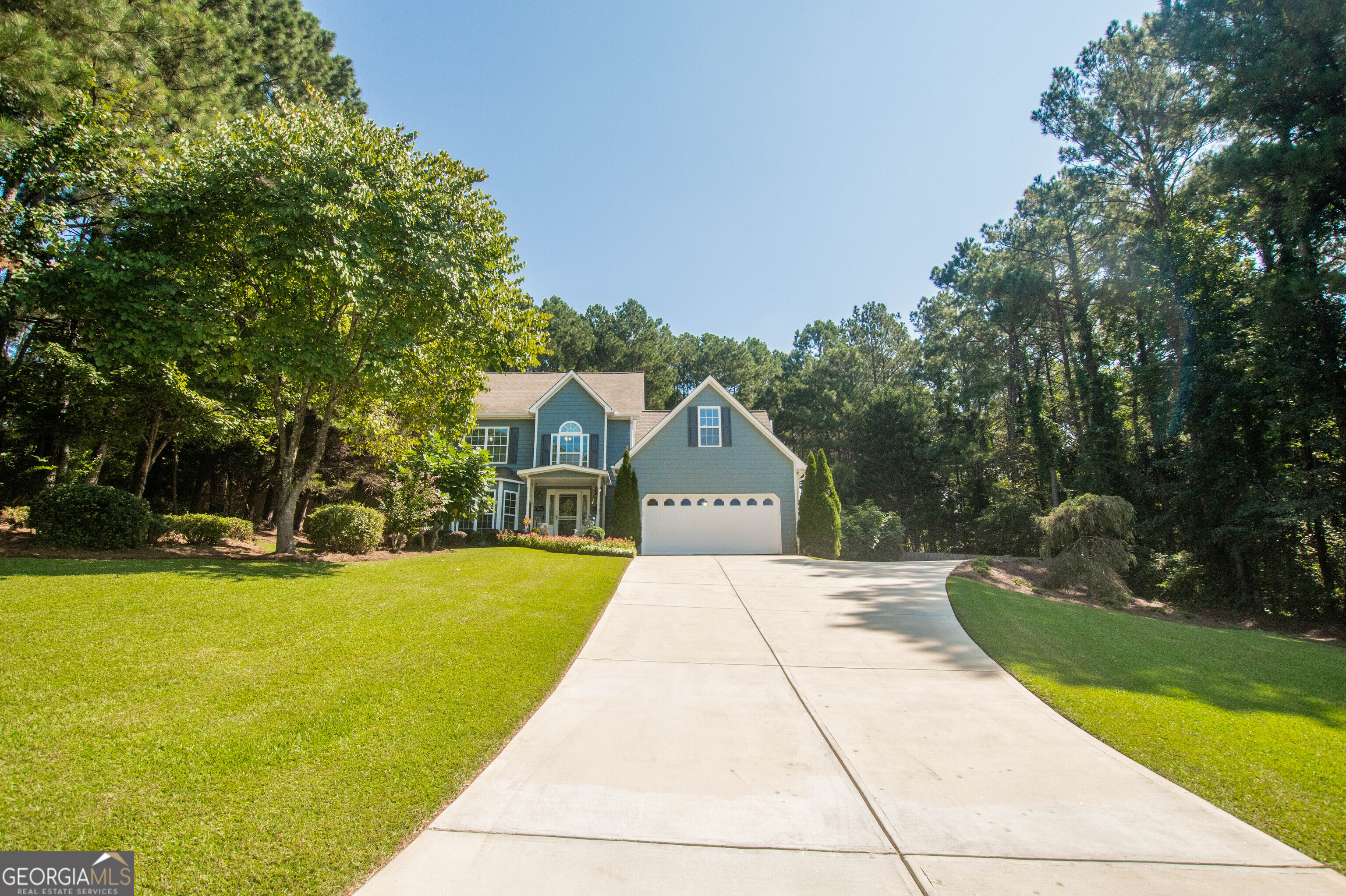 Welcome to 4971 Cliff Top Drive! This warm and inviting 4 bedroom/2.5 bathroom home sits on over an acre and offers a fenced backyard with a 850 square foot workshop with electricity in place. The kitchen features granite countertops, stainless steel appliances, backsplash, lots of cabinets, a pantry, breakfast bar, and an eat-in dining area. Off the kitchen area you will find a separate dining room with shiplap walls, plus a half bath. Also on the main level is an oversized great room with a cozy stacked stone fireplace, plus a flex room with French doors that would make an ideal sitting room, playroom or office space. Upstairs you will find the spacious master suite with a bathroom offering double vanities, tile shower and his/her closets. There is also 3 additional bedrooms, a full bathroom and laundry upstairs. This one-owner home has been meticulously maintained and offers charm, with lots of living space and ample room for storage. Exterior features include an attached 2-car garage, plus an extended concrete pad for parking, a welcoming rocking chair front porch, and an oversized rear screened porch perfect for your morning coffee. Newer HVAC and water heater. Fresh paint and new flooring. Newly updated light fixtures, windows and concrete siding. Loganville school district. The home is conveniently located near shopping, schools, restaurants, golf courses and entertainment. Buyers will not be disappointed!