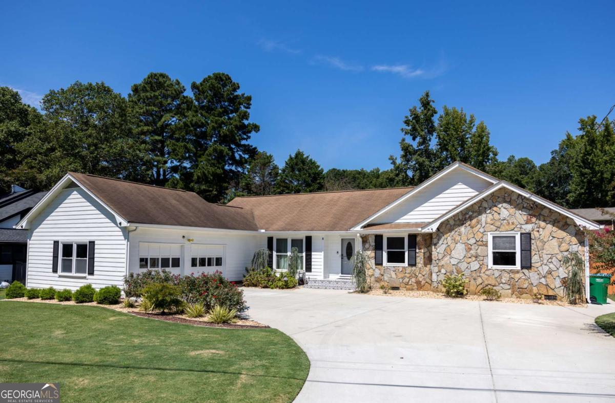 This charming single-level ranch is a true stunner, set on a spacious level lot with over $100K in thoughtful full renovations. Step inside and enjoy the warmth of real hardwood floors, modern light fixtures, and fully upgraded bathrooms. The primary suite feels like a retreat looking on green level backyard, double vanity, and frameless glass shower. Behind the scenes, major improvements include newer HVAC and updated systems-move-in ready peace of mind! The no-HOA community is tucked away yet just minutes from I-85 & I-285, giving you unbeatable access to shopping, dining, and entertainment. Whether you're looking for a family home, multi-generational living, or a savvy investment, this one has it all. Investor-friendly, spacious, and stylish-don't wait, homes like this go fast!
