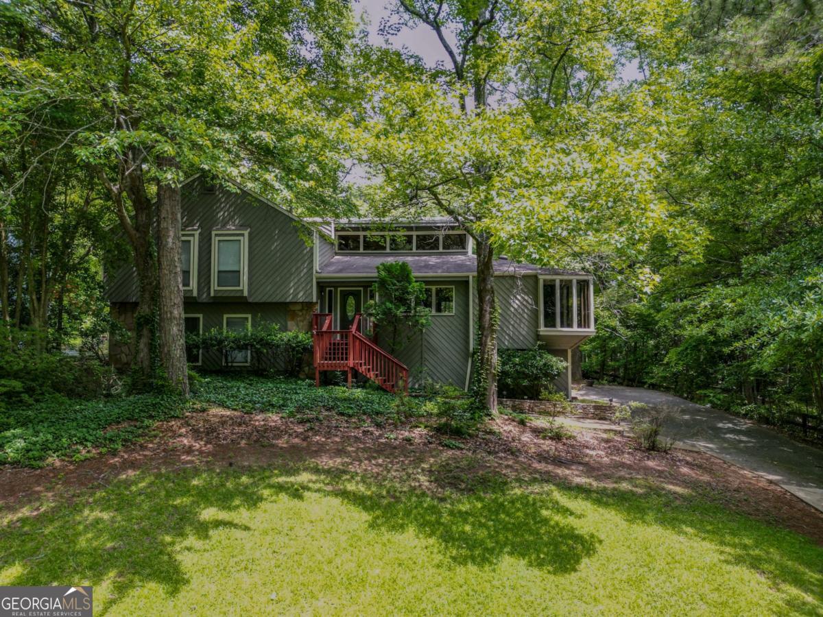 Charming split-level 4 bedroom, 3 full bath home in the highly sought after Pope High School district. Huge, flat and fully fenced backyard with deck and patio that's perfect for play and/or entertainment. Living room features a stone wood-burning fireplace w/ gas starter, laminate wood floors, and tall ceilings with exposed cedar wood beams. Plenty of windows and beautiful skylights throughout that bring in an abundance of natural light. Kitchen has breakfast area, pantry, stained cabinets, granite countertops, and separate dining room. Interior also features ceiling fans, walk-in closets and plenty of space. Oversized 2-car garage. Quiet cul-de-sac street. Available now.
