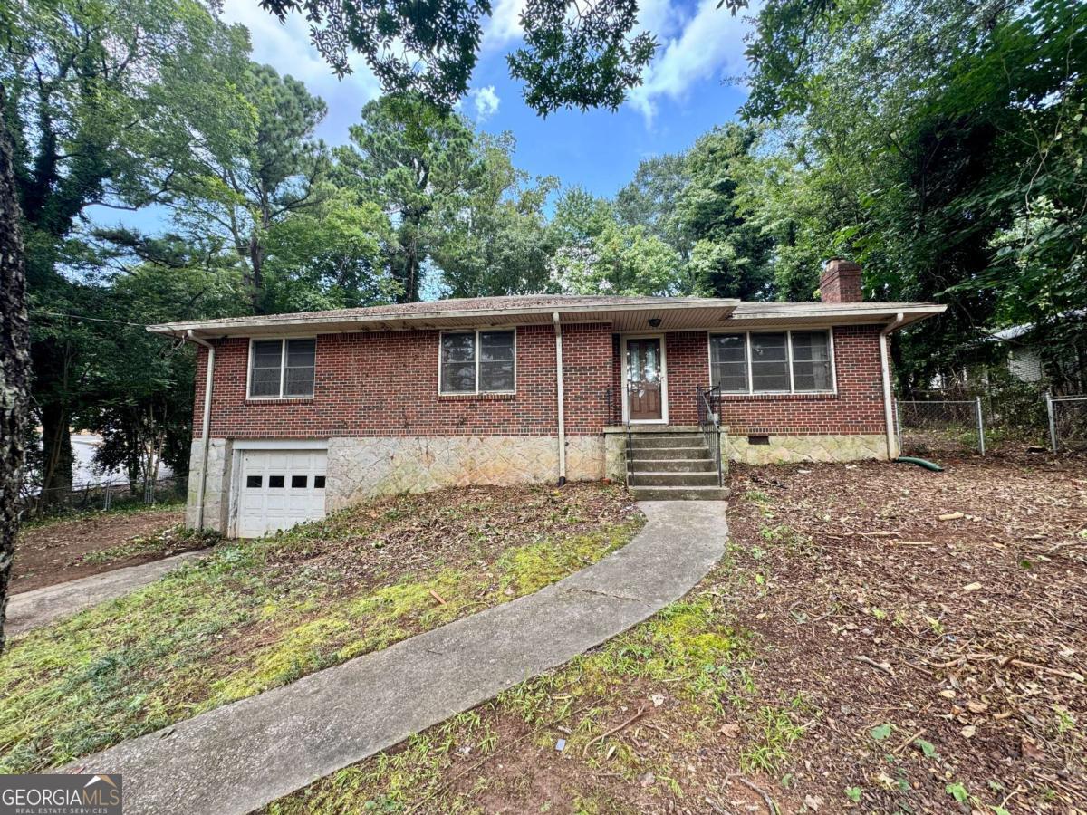 Rare Fixer-Upper truly in the heart of Toco Hills/ North Druid Hills at an unheard of price in the $300s! This raised brick ranch offers an exceptional 2,325 square feet of potential living space, including 1,641 finished square feet upstairs and 684 square feet of unfinished basement space ready for customization. The basement currently includes a 1-car garage, a rare feature in this age home, ideal to keep as parking and still have a finished bonus room in the basement, or convert the garage into a 4th bedroom plus bonus room for expanded living space. The home sits on a large, cleared, fenced half-acre lot, with plenty of room to the left of the home for a carport, garage, or an addition, adding even more value and versatility. Inside, you'll find a spacious fireplace family room and formal living room that can be opened up to the kitchen to create a modern, wide-open floor plan perfect for today's living. Original hardwood floors run throughout the main level, and the home is easily convertible into a two full bath layout, maximizing both function and resale value. Located at the center of Toco Hills, check the map to see how close this this property is to the Toco Hills shopping plaza and Publix, and only 1 mile ~30 min walk to Emory University and the VA Hospital. A clear septic inspection letter is in hand, making this property ideal for real estate investors or homeowners using a renovation loan to create their dream home in a highly sought-after location. Opportunities like this are incredibly rare-don't miss your chance to unlock serious upside in a premier neighborhood at an unbeatable price.