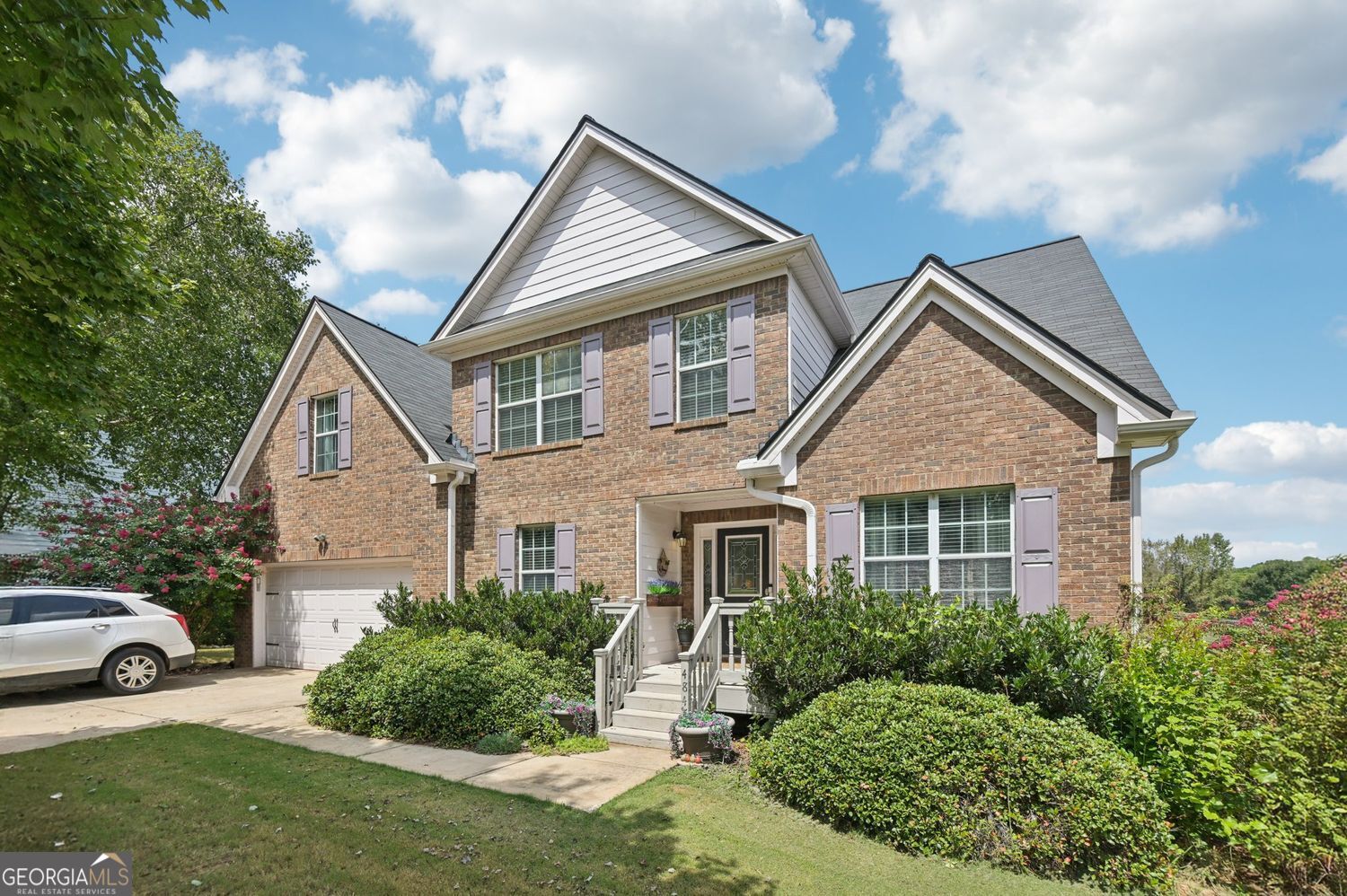 Welcome to 4845 Haley Farms Drive! This inviting 5-bedroom, 2.5-bath home sits on over half an acre with a flat, fenced backyard-perfect for outdoor living and entertaining. The primary suite on the main level offers comfort and privacy, complete with a spacious bath and generous closet space. The bright kitchen, open to the breakfast room, flows seamlessly into the family room with a cozy fireplace, while the spacious dining room with hardwood floors sets the stage for memorable gatherings. Enjoy mornings or evenings on the large rear deck overlooking the serene backyard. Upstairs, you'll find four oversized secondary bedrooms, all with ample closet space, and a full bath, ideal for family or guests. Recent updates include fresh paint, new carpet, and a roof and water heater only 3 years old, making this home move-in ready. A laundry room on the main level adds convenience, and the unfinished walkout basement is ready for your finishing touches. Located near Cumming City Center, with easy access to GA-400, shopping, and dining, and zoned to excellent Forsyth County Schools, this home truly has it all!