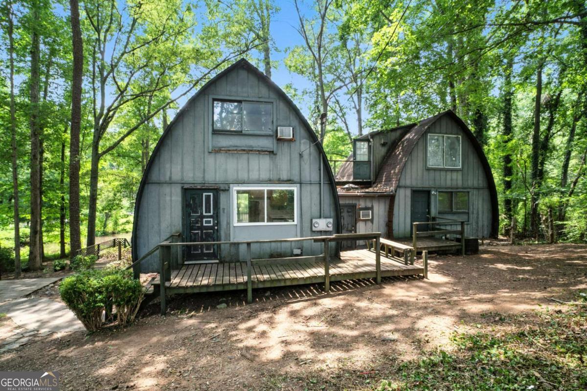 INVESTOR SPECIAL, PRICED ~$100K-150K BELOW AREA COMPS! This 3 bed/2.5 bath home on almost 3 acres could be perfect for a Fix & Flip, Buy & Hold, Airbnb, or owner occupant looking to invest some sweat equity. Unique opportunity to own this one of a kind property on almost 3 acres with a private pond and dock! Home in need of cosmetic updates. Big front porch and large back deck that overlooks the pond. Large living room flows into the kitchen and dining room. Large family room with wet bar and spiral staircase. Upstairs there is three bedrooms and two full bathrooms with another room perfect for a bonus room/office. Out back the massive back deck overlooks the private pond with dock. Property also offers a storage shed.