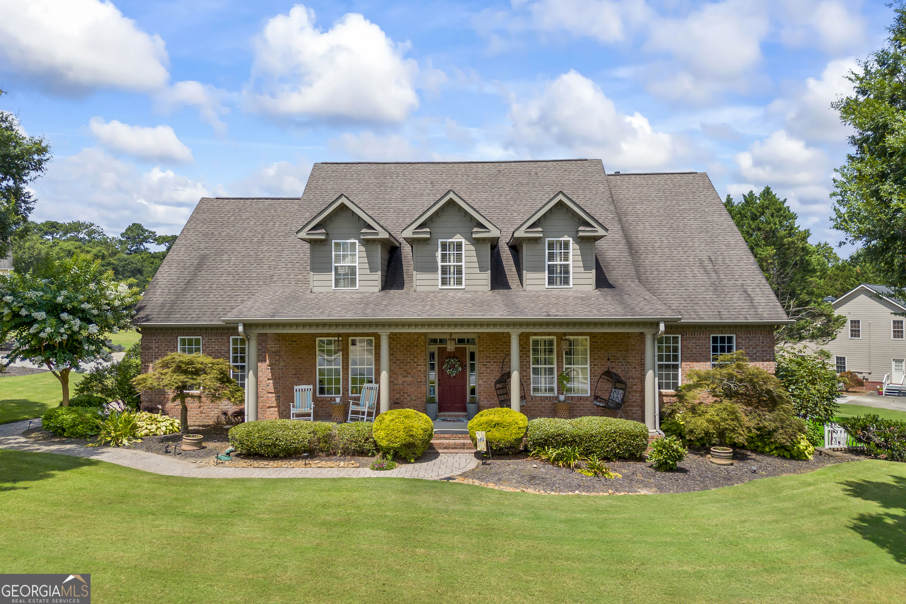 Coming soon to the market! ** Open house on Saturday 7/26 from 10-12** Welcome to 395 Reece Drive - an exceptional all-brick residence nestled on a desirable corner lot in one of Hoschton's most sought after communities. With three levels, this expansive 3,576 sq.ft. home combines timeless architecture, thoughtful design, and premium amenities for ultimate comfort and functionality. Inside, you'll find 4 spacious bedrooms, 3.5 bathrooms, a dedicated office, dining room, and more! Through to the heart of the home is the kitchen, which features custom white cabinetry, a built-in wall oven and microwave, a kitchen island with a gas cooktop, a walk-in pantry, as well as a cozy breakfast nook, and direct access to the formal dining room. The living room has a beautiful stone fireplace, detailed 10+ foot ceilings, built-in shelving, and direct access to the expansive back deck-ideal for indoor-outdoor entertaining. On the main-level, the master suite is generously sized and enhanced with tall ceilings that create an elevated feel. The en-suite bathroom includes dual walk-in closets, double vanities, a separate shower and soaking tub. Two generously sized bedrooms are located upstairs, along with a shared full bathroom, a large hallway, and ample closet space. Downstairs, the basement offers a massive recreation room, additional sitting areas, extra storage, and flexible rooms ideal for a gym, or a hobby space. Outdoor living is just as impressive, featuring a large back deck perfect for grilling, a beautiful stone patio with a built-in fire pit, and a fully fenced backyard ideal for pets or play. The community offers resort-style amenities including a swimming pool, tennis courts, clubhouse, playground, and picnic areas - perfect for family fun and neighborhood gatherings. Don't miss your chance to own this move-in-ready home in a vibrant community just minutes from top schools, shopping, and dining.