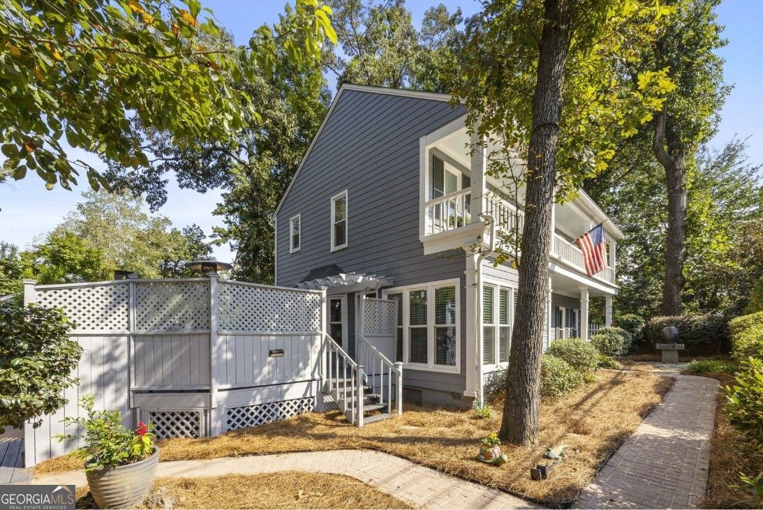 This fully renovated Collier Hills home offers what almost no other home in the neighborhood can: light-filled rooms, soaring ceilings, wide-open living spaces, and every finish buyers crave. Because the original build was decades later than almost every other home in Collier Hills, you'll find the rooms flow better than in the typical cottage-it's the unicorn buyers hope for but rarely find here. Access off Northside is a breeze thanks to the rear alley entrance that connects all the way to Cottage Lane; and the home boasts a three-car parking pad plus a rare two-car garage (five spots total). Step inside the back gate and you'll find that the fully fenced backyard is a private oasis with an expansive entertainer's deck and plenty of green space. Yes, it sits back from a busy corner-but once you're inside the gate, you'll be surprised by how private and serene it feels. From the charming front porch, you'll step into a two-story foyer; this floor has a gourmet kitchen with warm wood cabinets, quartz countertops, a six-burner range, separate island and breakfast nook, with a convenient adjacent office/bonus room and charming powder room. There is a separate dining area that flows into the great room with custom built-ins and a gorgeous floor-to-ceiling fireplace. Upstairs, the stunning oversized primary suite boasts a second fireplace, seating area, and spa-like bath with dual vanities and bespoke tiled shower. Step across the hall to find the convenient laundry area and two beautiful guest rooms, each with its own en-suite bath. This home blends the best of both worlds: the character and location of Collier Hills with the flow, scale, and modern finishes of a newer build. Steps from the Atlanta BeltLine, Tanyard Creek Park, Bobby Jones Golf Course, Bitsy Grant Tennis Center, and favorite shops and restaurants-this is the rare Collier Hills opportunity that truly checks every box. A rare find where location, lifestyle, and luxury align.