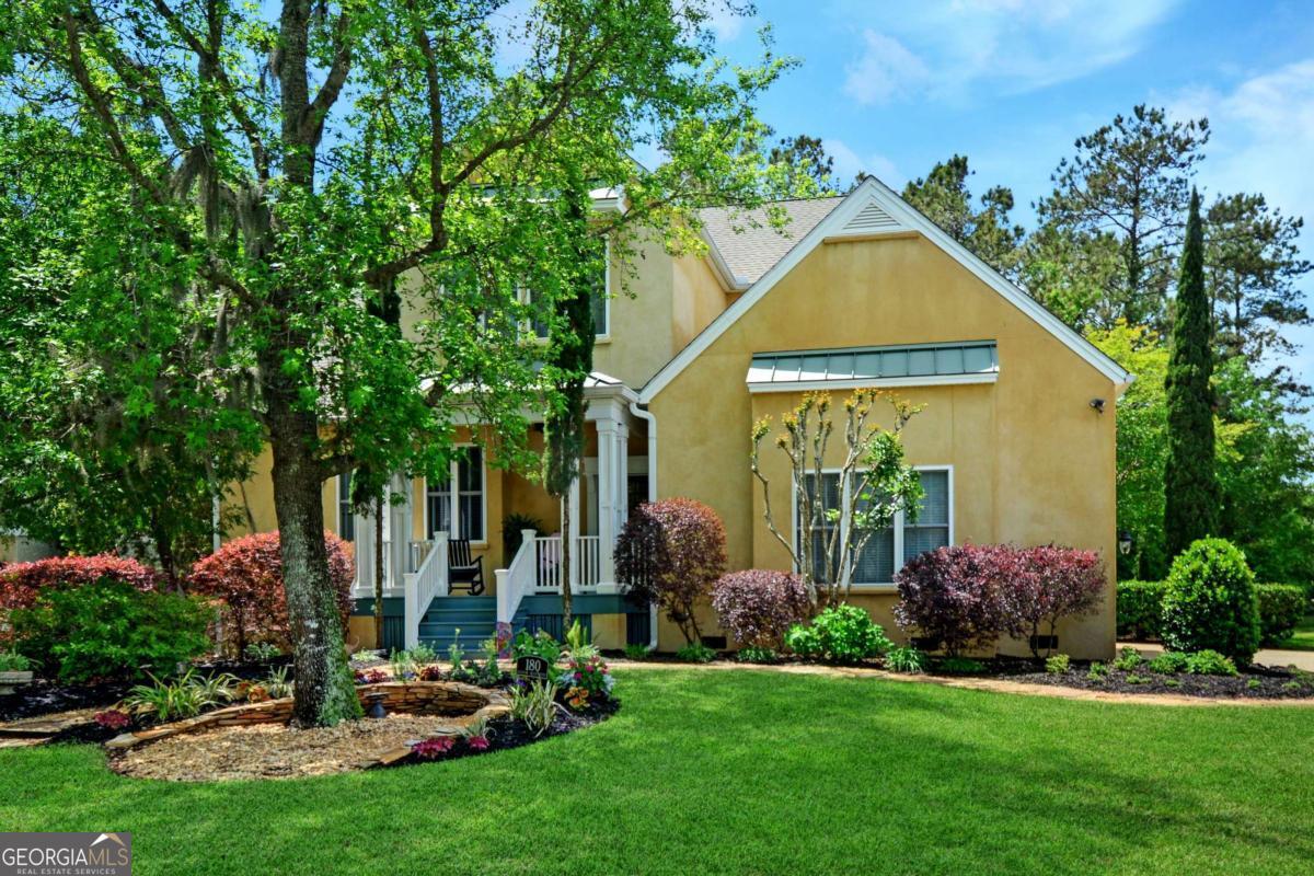 Inspired by their love for European architecture, these owners had their four bedroom home custom designed and constructed to incorporate the old world warmth and charm of an Italian Villa. This functional floor plan is perfect for entertaining guests with an easy flow between living room, kitchen, dining and sunroom. The welcoming entry opens to a charming reading nook/library which could also be used as a music room. The living room hosts soaring 21'ceilings, wainscoting and a gas log/see through fireplace. The custom cabinetry in the kitchen is a work of art and is as functional as it is attractive. A sun filled dining room faces the private back yard. The highlight of this home is the stunning sunroom, with cathedral ceiling accented by wooden beams, a fireplace, and an abundance of windows overlooking a natural designated "wetlands." The sunroom adjoins a delightful terrace accented by a foutain and pergola, evoking the ambiance of Tuscany . The spacious primary bedroom suite is located on the 1st floor and the beautiful tiled bath has a generous shower and double vanities. Off the hallway to the garage is a separate laundry room with additional cabinetry on one side and a built-in desk with bookshelves on the other. There are hardwood floors throughout the 1st floor. Upstairs, three additional bedrooms share a well appointed bath, with the largest bedroom offering flexible use as a media room, office or den. A convenient walk-in attic provides easy-access storage. The home is served by 2 HVAC systems - the 1st floor unit was replaced in 2018 and 2nd floor in 2021. Throughout the house are quality features found only in custom homes - elaborate trim work, custom cabinetry, unique windows and so much more. An added plus is the corner lot location. Oak Forest Subdivision has grown in popularity due to the proximity to the causeway and the access to a traffic light on to Demere Road. Easy drive to grocery stores and only 3 miles to the beach. This home is a rare blend of classic timeless beauty that will always be in style.
