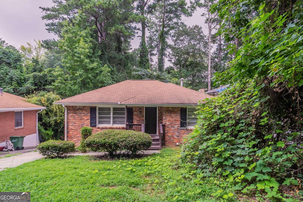 Discover potential in this classic 4-sided brick ranch located in the Westwood Terrace neighborhood of Atlanta. Featuring hardwood floors, a partially finished basement, and a flexible bonus room that could serve as a third bedroom or home office, this home is ideal for a buyer with vision. The open dining/living area adds charm, while the spacious lot offers room to expand or personalize. Positioned near public transportation and downtown amenities, this home offers a great opportunity to own in an established neighborhood with long-term upside.