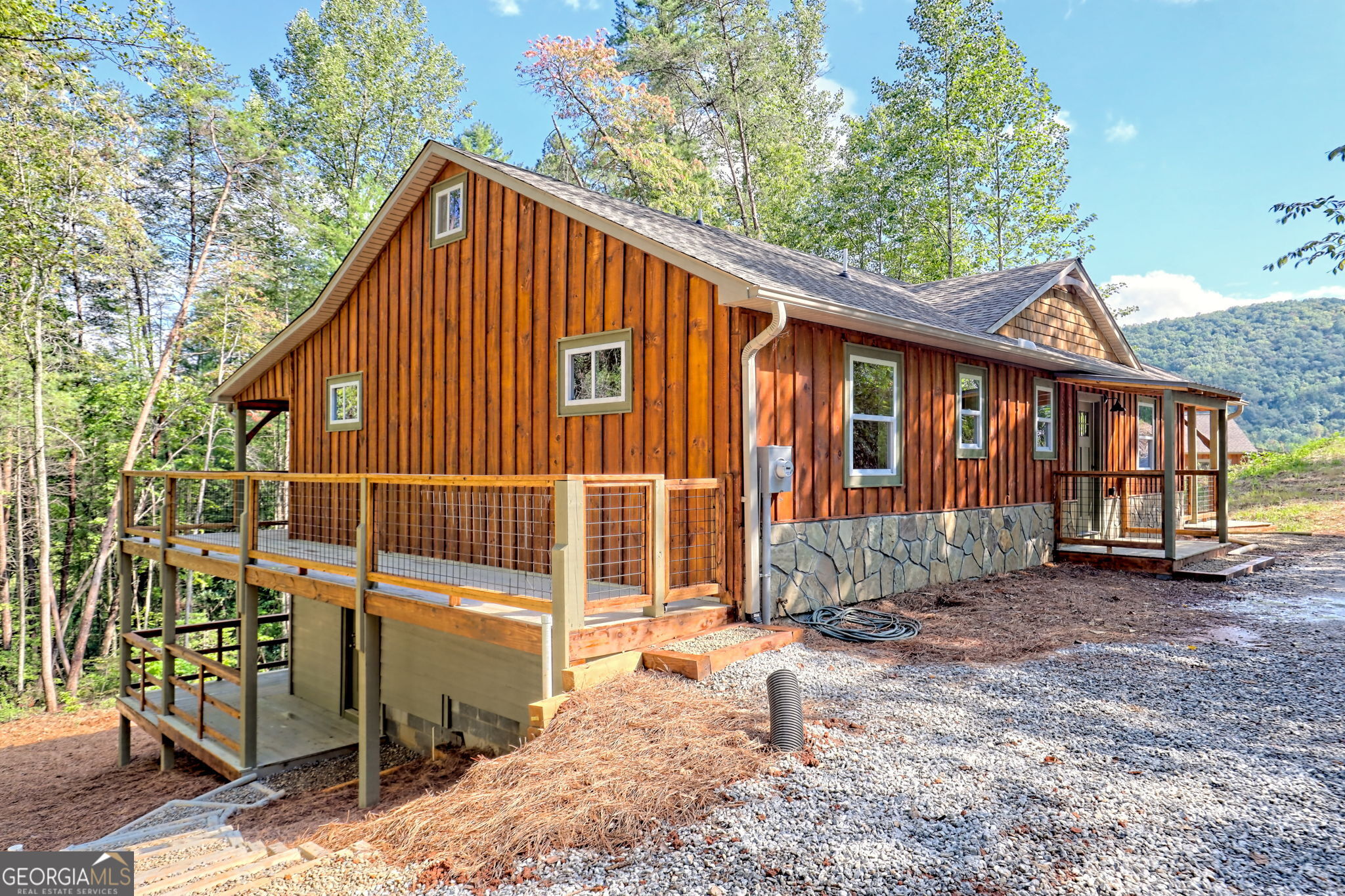 This stunning new construction mountain retreat in Bettys' Creek offers a spacious, cabin-style home with breathtaking long-range views and surrounding pastures, ideal for serene mountain living or a getaway. Inside, the open-concept design features vaulted ceilings, upscale finishes, a cozy stone fireplace, large windows, and a versatile loft bonus room perfect for a kids' office or additional space. The well-appointed kitchen showcases custom cabinets, counters, and stainless-steel appliances, while the primary suite ensures privacy and luxury. Ample storage, a walk-on deck, and proximity to excellent schools make this home a perfect blend of comfort, luxury, and mountain beauty.