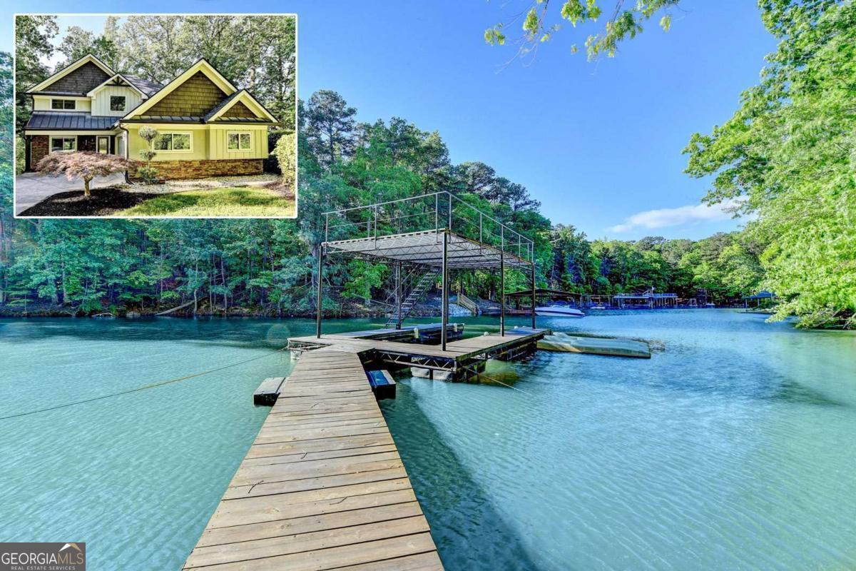 Lake Lanier Party Dock and 4 bed/ 4 bath Home WITH Full In-Law Suite. Looking for a change of pace? Live life with tons of fun during warm, sun-filled days. Whatever your water sport of choice; whether it's fishing, waterskiing, snorkeling, swimming, or boating, it's all here. NO HOA-Bring your toys!! Relax to nature's spectacular, sunset cruises and stay to watch the dreamy twinkling stars come out. Constellations are easy and fun to find. You've just found the perfect lake front/view cove. This home is perfect for entertaining, relaxation, watersports, or just as a second home to getaway. The main home has a stepless entry that opens to the large living room and separate sunroom. Picture your own style against this freshly painted neutral pallet. Open Floor plan on main level includes: hardwoods, moulding, stacked-stone fireside sunken Den, Dining Room and a Kitchen with a broad statement sized stone island with breakfast bar. Fabulous stove top that would delight a chef. Walk-in pantry. Grab a favorite book and relax in the Indoor-outdoor living space as you step out onto the screened in porch boasting a vaulted ceiling with fan. There are stairs from the porch that lead right to the lake's cove and dock. Owners' suite has a view of the cove from the windows on the back of the home along with walk-in closet, large enough for king-sized furniture, and private bathroom. 3 upstairs bedrooms, split bedroom plan, with 2 full bathrooms. Immaculate and move-in ready. In-Law Suite has a 1 bed/1bath, kitchen and its own living room. Private entrance or use the interior steps with wrought iron rails, and hardwoods. Fantastic space for the very sought after multigenerational life style. It can be used as a teen suite, extra living space, guest apartment, or roommate plan. Bells and Whistles include: Judges panel, vaulted ceilings, 2 rear decks, Tray ceilings, Coffered ceilings, antique styled ceilings, wood inlay in den, chef's kitchen, built in closet/organizer, Beadboard, warming fireplace style at oversized tub in in-law suite, french doors and so much more!! Lots of parking between the 2 car side entry garage and extended parking in driveway. Minutes to marketplace Boulevard where there is a Costco, BJ's, Walmart, Outback Steakhouse, Longhorn, Provino's, Chipolte, petco, Ulta, Lowes, Ross, TJ Maxx, HomeGoods to name a few. Hwy 400 is just a few minutes away. About 50 or so miles to Hartsfield Jackson, International Airport. Leave the hectic, hustle, bustle, and chaos behind. Go on and step down the Park-like walk from the home to a 1 slip dock and 2 personal watercraft floating docks. Float on over quickly to Bald Ridge Marina and gas up, largest portion of the lake is South at Buford Dam, just minutes away. Margaritaville with its fireworks on major holidays and varies through the year. Port Royal, Pelican Petes, Pig Tails and Fish Tails are great to dock your boat and get a beverage and a bite to eat. Lake living is its own laid-back lifestyle. Come enjoy it!