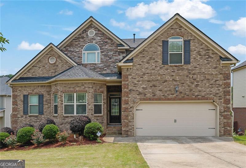 Stunning 4-Bedroom, 3.5-Bath Home in Highly Sought-After Whispering Lakes Community & East Forsyth High School Cluster! From the moment you step inside, this home will impress! The grand two-story foyer and gleaming solid hardwood floors set the tone for the elegance that follows. An oversized formal dining room with charming bay windows offers the perfect space for entertaining. The spacious family room boasts a coffered ceiling, a cozy stone fireplace, and access to a covered deck overlooking a fully fenced backyard-ideal for relaxing or hosting gatherings. The gourmet eat-in kitchen features granite countertops, stainless steel appliances, an island, and a dedicated coffee/appliance bar. The updated main-level laundry room includes granite counters and added cabinetry for enhanced functionality. You'll love the oversized Master on Main Suite, a true retreat with a vaulted tray ceiling and bay windows. The luxurious en-suite bathroom features double vanities, a soaking tub, a separate shower, a private water closet, and a generous walk-in closet. Upstairs, you'll find three spacious bedrooms-all with vaulted ceilings and walk-in closets. One bedroom includes a private bath, making it ideal for guests. The remaining two share a Jack & Jill setup, each with their own private sink area. A large loft completes the upper level, perfect for a media room, home office, or playroom. The home sits on a full, unfinished basement, offering endless possibilities! Use it immediately as a gym or storage space, or finish it to create an in-law suite, rec room, additional bedrooms, or the ultimate man cave. Enjoy the large, private fenced yard that backs up to woods and features an extended patio-perfect for summer barbecues and entertaining! New roof in 2024. Community amenities include a pool, green space, play area, and lake! This home is centrally located, just 3 minutes from GA 400 and 8 minutes to the North GA Outlets. Minutes from the highly coveted East Forsyth High School, Lanierland Park, Sawnee Mountain, shops, and restaurants. DON'T miss out on this Gem. Schedule your showing and make this DREAM home your REALITY today!