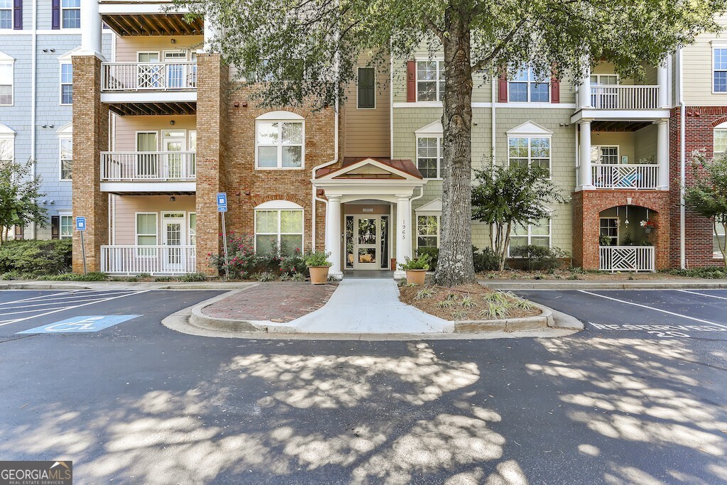 Sophisticated Condo Living in the Heart of Alpharetta ? Step into this move-in-ready home where style meets convenience. Thoughtfully upgraded with a new HVAC and water heater, luxury vinyl plank flooring throughout, and a newly vented kitchen hood-a rare and highly desirable feature in condo living. Smart home touches, including a surround sound system, smart thermostat, and smart lock, make everyday living effortless. The split-bedroom layout ensures privacy, with each suite featuring a walk-in closet. The primary retreat shines with double vanities, a soaking tub, and separate shower, along with added armoires for extra storage. The open-concept kitchen and living space is perfect for entertaining, while your private balcony offers a quiet place to unwind. Located on the first floor of a secured building, convenience is key with your assigned parking spot just steps away. Community perks abound-gazebo, pet area, green space, and swimming pool access right across the street. All this, and you're moments from Avalon, North Point Mall, Top Golf, Ameris Bank Amphitheater, and the vibrant downtowns of Alpharetta and Roswell, with easy access to GA-400.