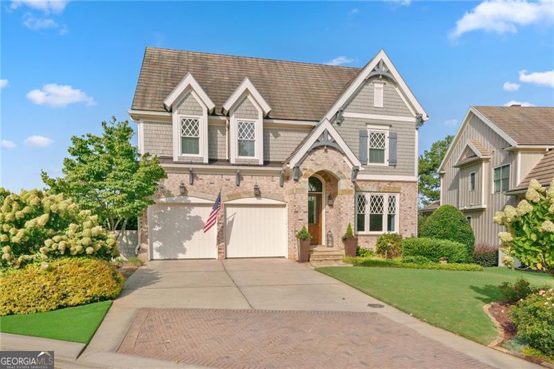 Discover a rare opportunity in the Cottages at Creekstone-this extraordinary 5 bedroom, 4.5 bath home is tucked away on one of the community's most picturesque lots, offering the perfect balance of elegance and comfort. The original owner has invested in over $100,000 of improvements throughout to make this home extra special including a brand new kitchen with quartz countertops and gold hardware accents! Sunlight fills every room through soaring windows, showcasing the open, airy design and white kitchen that seamlessly connects to the fireside family room with custom lighted bookcases. The main-level master suite is a serene retreat, while the spacious upstairs bedrooms ensure everyone has room to unwind, with laundry on both levels for ultimate convenience. The daylight basement expands the living space with a bedroom, full bath, kitchenette and media room that opens to a covered screened patio with a dry-deck ceiling above, overlooking a beautifully landscaped, fenced backyard-complete with outdoor fireplace and fire pit, ideal for entertaining or quiet evenings under the stars. This home is move-in ready! Cottages at Creekstone is the only community that shares Creekstone Estates' coveted 5-star amenities and an unmatched South Forsyth location near Halcyon, The Collection, hospitals, major highways, and the future Gathering at South Forsyth, this home invites you to live the lifestyle you've been dreaming of in South Forsyth!