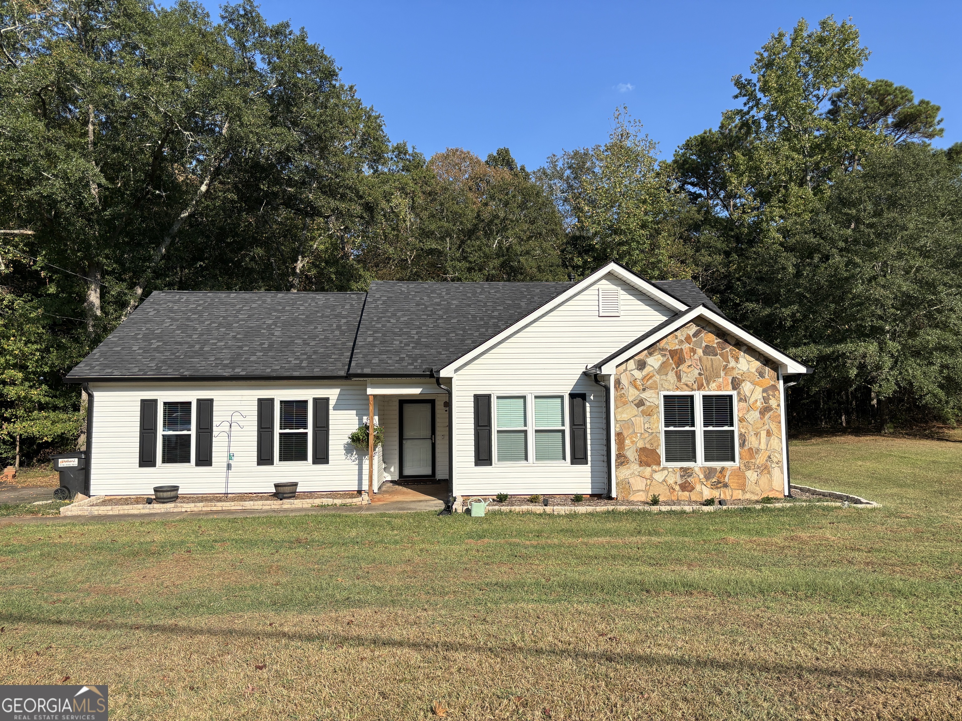 Welcome to this adorable 3-bedroom ranch in North Coweta. This home features a level lot, new vinyl siding, new windows, new roof and a recently converted garage into a large family/media room. Quiet neighborhood close to I85.