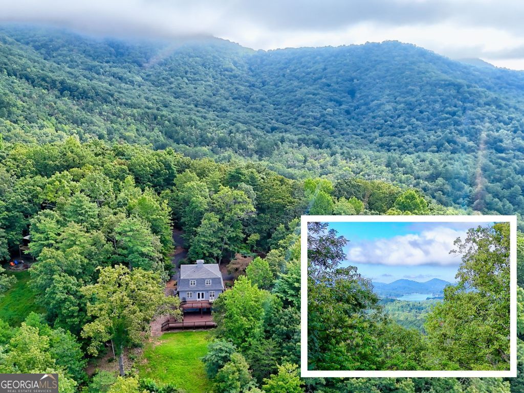 Enjoy breathtaking lake views in this charming 2-bedroom, 2-bath cottage just north of Lake Chatuge. Discover a well-designed main level featuring an inviting kitchen, dining area, laundry room, half bath, and a comfortable living room filled with natural light. The gas log fireplace adds warmth for cool evenings, and the spacious rear deck is perfect for morning coffee and stunning sunset views. The upper level features two bedrooms, each featuring its own en-suite bath and generous walk-in closet. The lower level offers a finished flex space and garage door access, leading to a large deck that overlooks the backyard, an ideal area for entertaining and recreation. Improvements include a paved driveway with parking pad, new roof in 2022, updated light fixtures, interior paint in 2024, and a new deck and French doors, in addition to an improved landscape by creating a backyard area for playtime or gardening. The circular driveway provides ample parking space, making it a standout feature. This furnished cottage is ideal for a mountain retreat, profitable rental property or even your primary residence. Some personal items are excluded from furnishings - a list is available upon request. Nearby attractions include Lake Chatuge boat ramps, marinas, USFS hiking trails, recreation parks, restaurants and retailers of Hayesville or Hiawassee.