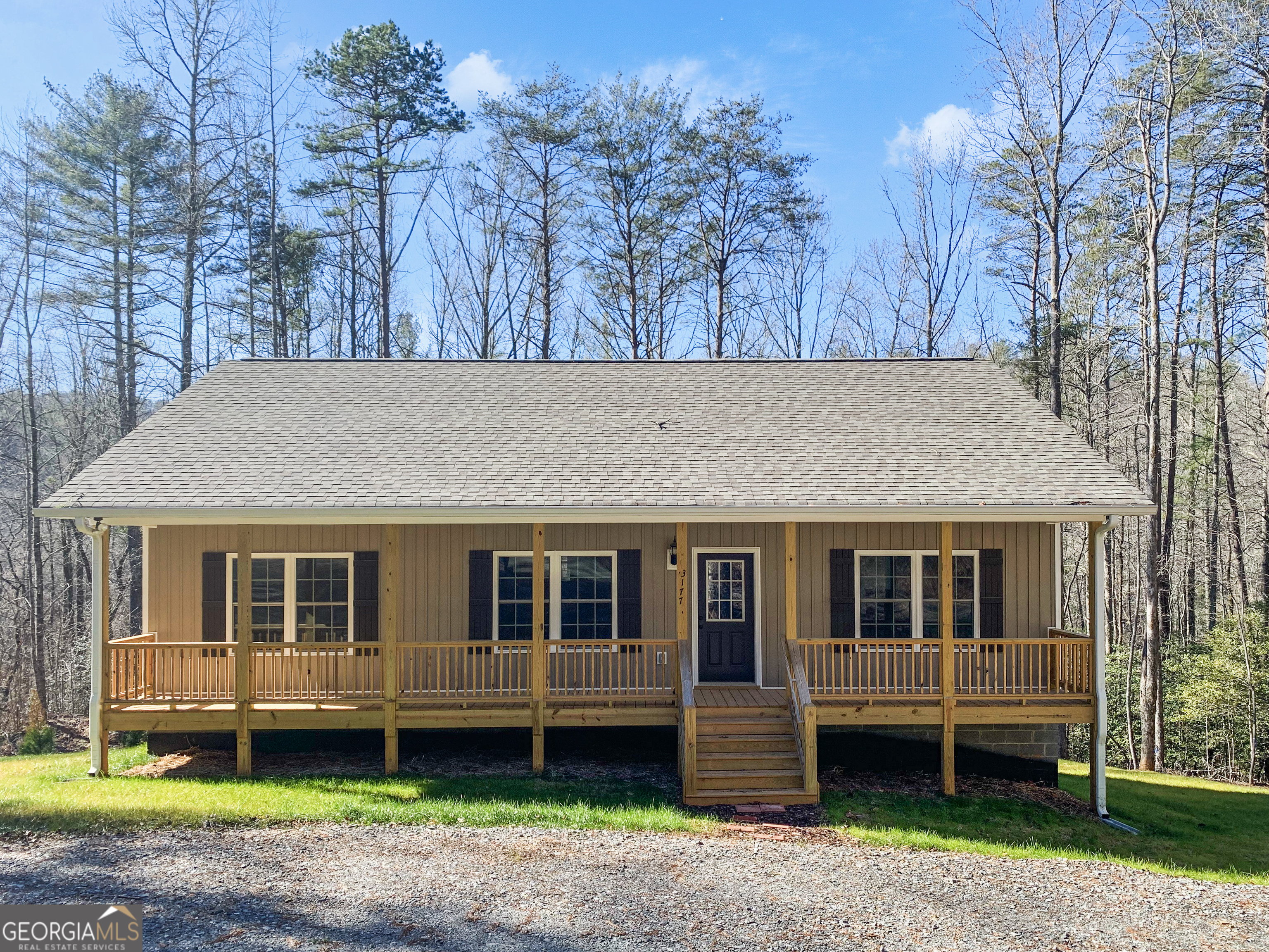 CREEK FRONT MOUNTAIN HOME - Welcome to the North Georgia Mountains. This 3 Bedroom with 2 Full Bath Home BUILT IN 2023 features Open Great Room, Kitchen with Island and Granite Countertops, Laundry Room, Master Bedroom with Walk-In Closet, Master Bath with Soaking Tub and Separate Tile Shower. The Exterior Boasts Rocking Chair Front Porch with Circular Drive, Relaxing Back Porch with Creek View, Level Lot Cleared to Beautiful Rodgers Creek, Lots of Storage in Stand Up Crawl Space and Easy Maintenance Vinyl Siding. This 1.22 Acre Level Lot is perfect for Entertaining, Gardening and Very Kid Friendly.