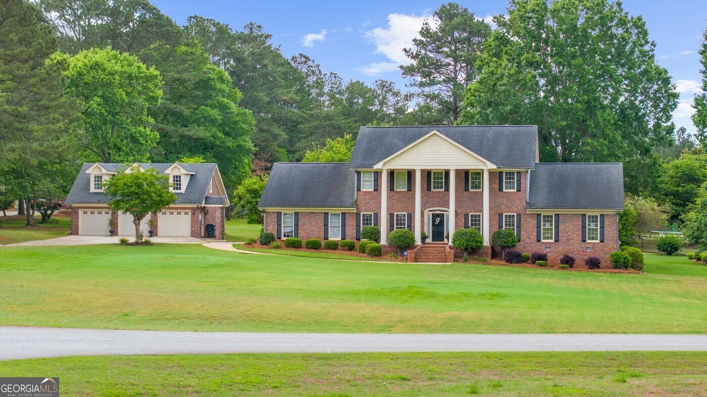 Welcome to your dream home! This beautifully maintained 4-bedroom, 3.5-bath residence sits on a spacious and level 1.3-acre lot, offering privacy, functionality, and plenty of room to entertain. Constructed with timeless four-sided brick, this home combines classic charm with modern amenities. Enjoy summer days in the backyard oasis featuring a sparkling inground pool complete with a diving board perfect for fun-filled gatherings or relaxing weekends. A detached three-car garage provides ample parking and storage, and includes a loft space above ready to finish, ideal for a home office, or studio. Inside, the home offers generous living space, including a bright and inviting layout with room for everyone. Whether you're hosting friends or enjoying a quiet evening, this home has the space and features to accommodate your lifestyle. Don't miss your opportunity to own this rare gem with room to grow, both inside and out!