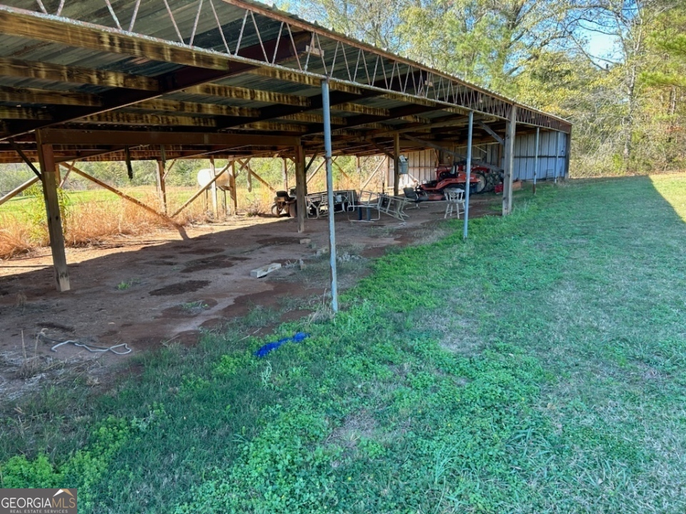 5 +/- beautiful acres fenced formally used as an airplane landing strip. 30x80 storage area under roof formally used as an airplane hanger. property can be divided and be 2 building lots.