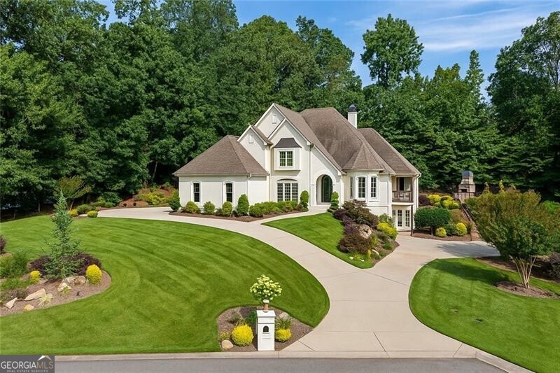 Amazing, unique gem tucked away on a huge cul de sac in Chateau Elan. Located behind the gates of the prestigious Chateau Elan community, 133 Bordeaux Way offers an exceptional blend of luxury and lifestyle. With the primary on the main and an expanded two story primary suite with living space and en suite upstairs with sky lights and adds an ADDITIONAL 1,000 square feet of living space. This resort style pool home is enveloped with gardens a waterfall and over an acre of land with potential to add basketball court or more gardens or leave as is. The front and backyard are a Yard Lover's Oasis complete with new irrigation. Enjoy lush, professionally designed landscaping in both the front and back yards, creating a serene retreat you'll love coming home to. The fully fenced backyard features a resort style walk out pool (on the main level) 1/2 bath so guests do not have to go into the house, a tranquil waterfall, an enviable yard perfect for relaxing or entertaining. Added peace of mind comes with security cameras surrounding the entire exterior of the home. In addition to Chateau Elan's renowned golf courses, restaurants and amenities, residents enjoy access to a state-of-the-art gym, fitness classes, indoor basketball, tennis, pickle ball, and a resort-style pool complete with water park features with membership. Access to all of these amenities are easily accessed from the cul de sac via golf cart within minutes! The chef's kitchen on Bordeaux has undergone a complete transformation. Featuring a 60" Viking gas range with 6 burners, a grill and griddle, and state of the art hood. Two stainless Miele dishwashers and ample storage complete the double stacked 12 foot honed marble island. A custom Miele plumbed coffee system to make cappuccion/espresso/latte/hot tea and convection microwave oven add to the appliances. There is also a dedicated ice machine and beverage center and ample quartz counter tops complete this extraordinary kitchen. 2 Stainless Steele Viking refrigerators/ freezers add to this masterful kitchen with new maple cabinetry. The living room now boasts floating maple shelves and tile to the ceiling over the fireplace. The secondary bedrooms upstairs are spacious and all have skylights. 2 rooms share a large jack and jill with separate sinks, another en suite and the en suite second primary with living area (or added Junior primary) complete the second level. A new bar has been added in the basement, complete with double wine beverage centers, sinks, an ice maker, and BEER TAP. The home theater has been upgraded with premium speakers and new carpet. Additionally, there is an oversized garage on the basement level with enough room for a work station or maybe even a man cave! Throughout the home, every detail has been elevated: new solid oak hardwoods in the kitchen, custom-built laundry cabinetry, all-new stair railings, custom black iron and glass doors, fully repainted interiors, upgraded light fixtures and fans, and completely rewired electrical systems with new panels and switches. 133 Bordeaux Way is where thoughtful design meets resort-style living-all within one of Georgia's most coveted communities. *Chateau Elan offers buses for Hebron, GAC & Lakeview Academy