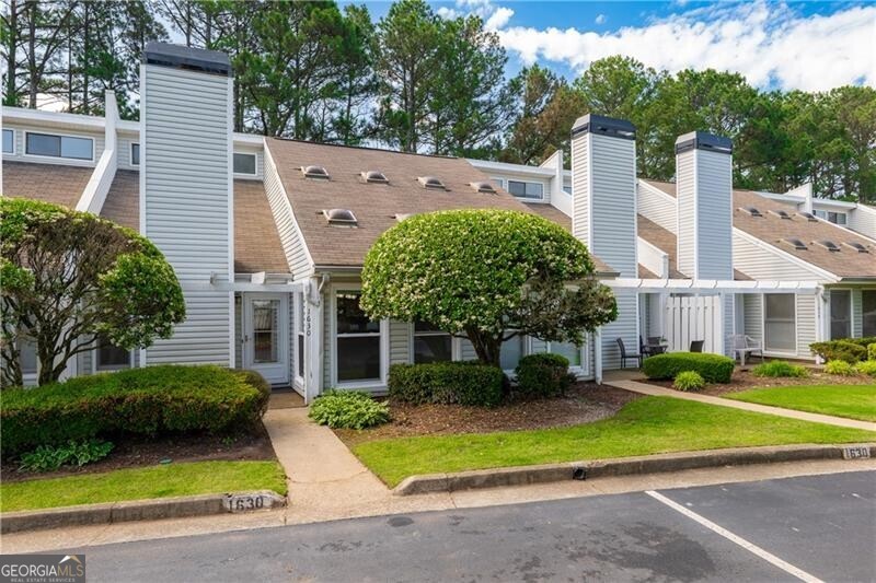 Summer is almost here and this condo is a conveniently located to downtown Alpharetta/Avalon which host many wonderful events throughout the summer months. The community is also near top-rated schools, shops, restaurants, offices, and GA 400. Upon entering the condo you will find new LPV flooring in the expansive living room with a gas fireplace, a galley kitchen with a dining area and an adjacent sunroom. The primary bedroom located on main floor has a spacious walk-in closet and has access to a rear patio with a privacy fence. The upper level includes a secondary bedroom, an additional room that can be used as a bedroom, home office, play/bonus/media/fitness room, a full bath and a separate laundry closet. Two assigned parking spots are located right outside the condos front door. The community amenities include a pool and tennis court. Do not miss out on this opportunities to tour one of the most affordable locations in Alpharetta perfect for a primary residence with a low maintenance lifestyle or rental income. No rental restriction cap, but rentals must be 6 months or longer. .