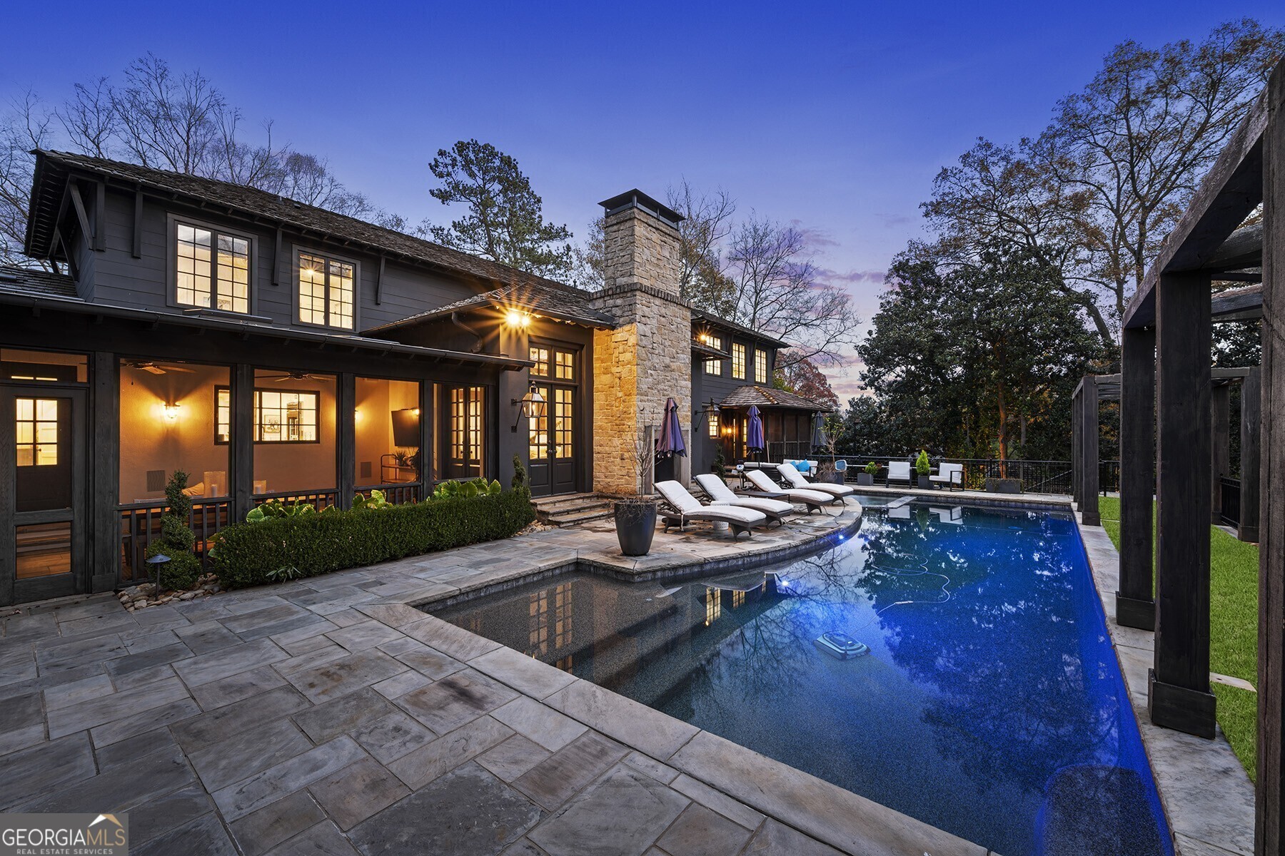 Welcome to this exquisite property, a stunning, fully gated, and renovated California-Modern retreat nestled in the heart of Buckhead on a quiet street in Tuxedo Park. As you step inside, you'll be greeted by the sprawling main floor adorned with 10-foot ceilings that create an open and airy ambiance. The distinctive hand-sewn beams, arched brick entryways, and elegant stone accents add character and charm to every corner. The recently renovated gourmet chef's kitchen boasts Miele appliances, an oversized quartzite island, large bar/butler area, with a full show-stopping open pantry and breakfast room. The main level of the home also features a formal living room, a fireside great room, and a dining room, each meticulously designed to provide an atmosphere of sophistication and comfort. Additionally, a gorgeous screened-in porch invites you to enjoy al fresco dining and extends the entertainment options for gracious hosting. Retreat to the primary suite located on the main level, where luxury and relaxation await. The spa-inspired bathroom boasts a soaking tub, an oversized marble shower, and dual large custom walk-in closets that provide ample storage space. A private porch off the primary suite offers a peaceful retreat where you can unwind and enjoy the tranquil surroundings. Step outside and discover the stunning backyard oasis, designed for resort-style outdoor living. Featuring a heated saltwater pool and spa, large Astro turf field and for the sports enthusiasts, a lighted pro-style Pickleball court awaits friendly competition. A grilling area ensures effortless outdoor cooking, and a flat open field provides ample space for outdoor activities and gatherings. 172 Blackland Drive offers generous parking options with three total garage bays. One is attached to the main house, offering convenient access. An additional two-bay detached garage provides even more space and features a full finished area above, perfect for an additional office, studio, or flex space.