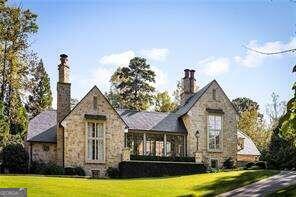 Discover one of the most beautiful homes in Atlanta, a stunning custom masterpiece designed by award-winning architect Stan Dixon, nestled in prestigious Tuxedo Park. This architectural marvel, entirely clad in Texas limestone with a slate roof, sits on a private hilltop and features professionally landscaped grounds by renowned Howard Design Studio. The breathtaking gallery serves as the central point of the home, showcasing soaring steel doors, limestone floors, and oak trim details, while floor-to-ceiling windows flood the space with natural light. The main level is perfect for entertaining, with picturesque views from every room, connecting the private sanctuary of the primary suite and fireside study on the left wing to the family room, breakfast room and chefCOs kitchen complete with high-end appliances and a separate scullery and pantry space. An inviting outdoor loggia features a wood-burning fireplace and grill overlooking the stunning pool, creating an ideal space for alfresco living. The upper level boasts a central gathering room with three guest suites, each offering beautiful bathrooms and spacious closets. Additional amenities include a whole house generator, Control4 home automation, Lutron lighting, audio system, and advanced security features, making this exceptional property a perfect blend of quality and style in one of Atlanta's most sought-after neighborhoods. DonCOt miss your chance to own this extraordinary homeCoschedule your private showing today!
