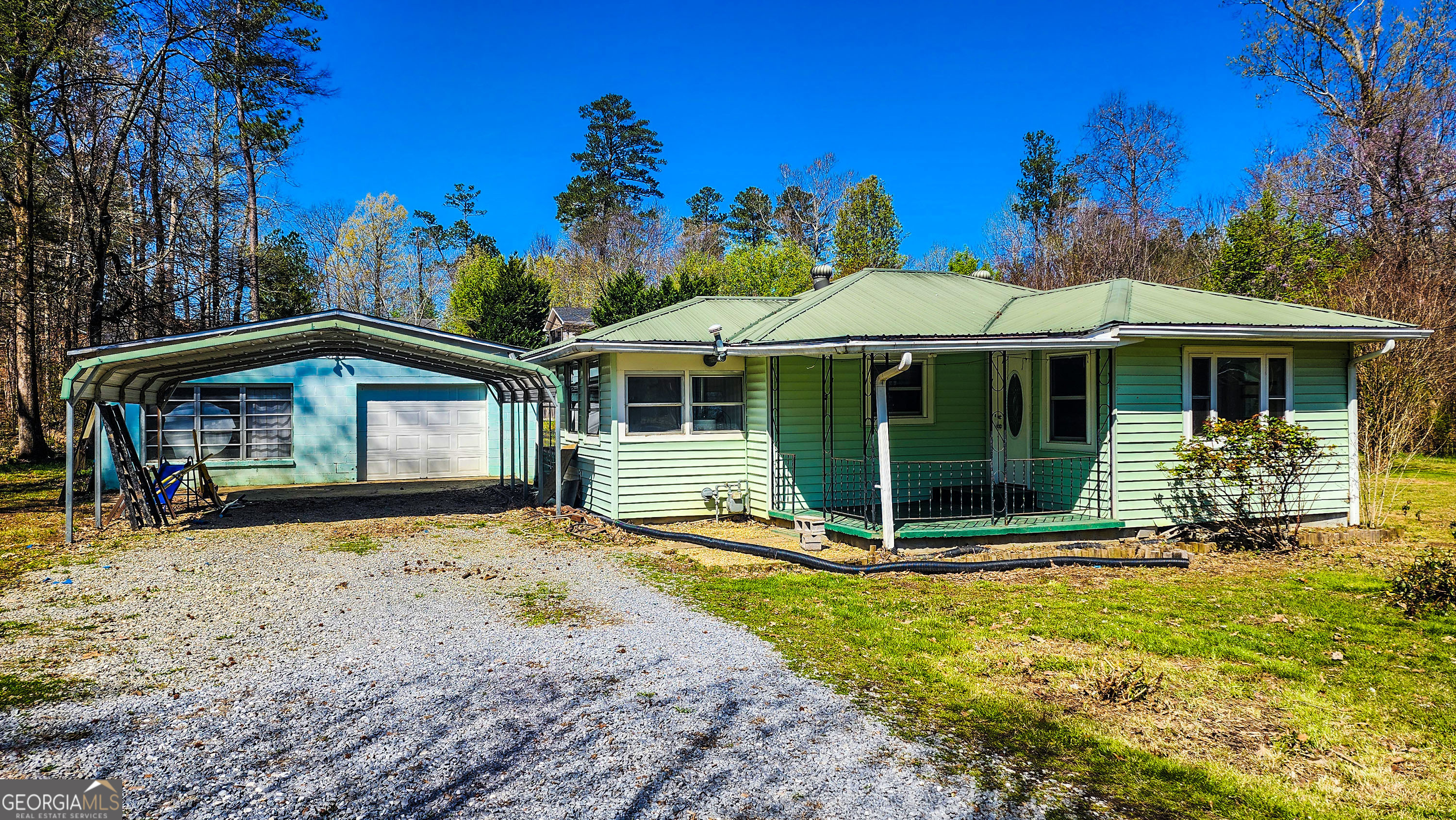 This home is conveniently located near schools, parks, shopping, and dining. A standout feature of this property is the larger garage that doubles as a workshop, offering plenty of space for tools, projects, or additional storage, perfect for hobbyists or anyone in need of extra room! In addition to the garage/shop there is a 2-car carport and an additional storage building. The house features two bedrooms, one full bathroom and original hardwood flooring. Seller has never lived in home. This property is being sold "as is." Home does need some repairs/updating. No FHA/USDA financing. Please call listing agent prior to any showings at (706)346-1250)