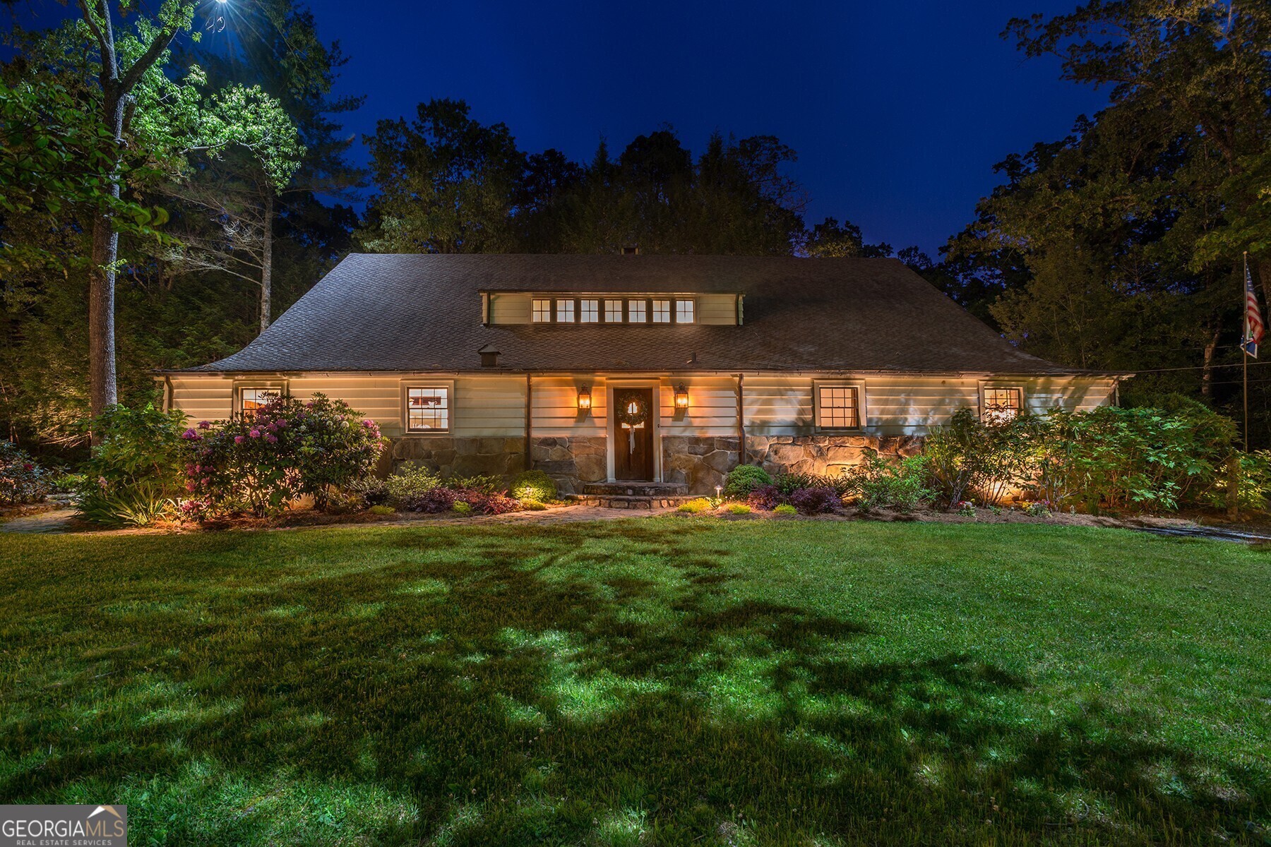 Enchanting! This Historic property offers multiple opportunities as an Inn, Bed and Breakfast, Hotel or Special Events venue! ONE OF A KIND LAKE RABUN PROPERTY! Exquisitely remodeled by skilled professionals who have preserved the fabulous native stone walls, stone flooring and timber! The heart-pine floors and striking features in this historic, 100 year-old structure will captivate! This property is a special part of Lakemont history. Originally built by the Samuel Candler Dobbs family for their horses, this stunning barn has been converted to a 7 bedroom, 8 full and 1 half bath luxury lodge. It is able to provide roomy accommodations for groups or intimate living for more private enjoyment. Enjoy multiple gathering spaces designed to impress for warm fireside conversations, cozy family interactions, impressive entertaining or the quiet media, TV room. Gather round the spacious double-dining area for family meals, grab a casual bite at the kitchen island or expand the party to the 1000 sq. ft outdoor deck for larger events. There is no limit to what the outstanding commercial grade kitchen can prepare, for gourmet feasts or a catered affair. There is more for your enjoyment outside on this beautiful property that boasts a view of Lake Rabun that offers the ideal setting any time of day or night! Throw a ball in the front yard green space, the perfect spot for sport. Relax in the afternoon under manicured hardwood trees. In the evening watch the sunset's dappled light from the comfort of Adirondack chairs, and at night with the grounds magically alive with the best professional lighting, gather round the stone firepit to roast marshmallows and tell moonlight stories. Walk to the Lake Rabun Marina for boat rentals and public boat launching ramp, great restaurants or the Lake Rabun Pavilion for community events. Conveniently located across the road from beautiful Lake Rabun where you will delight in all the water activities that this pristine lake affords! Additional pleasure awaits with nearby golf and tennis. Explore the outdoor adventures in the area: hiking, river rafting, trout fishing on the Soque River, kayaking at the Tallulah Gorge State Park or visit the Yarn Nature Center. Store all your gear in the large outbuilding which could be remodeled to be a garage. The horse-themed furnishings and accessories carefully curated by a well known interior designer add to the ambiance of this historic property . All the furnishings are available for purchase if you desire to have a turn-key, ready to move in property.
