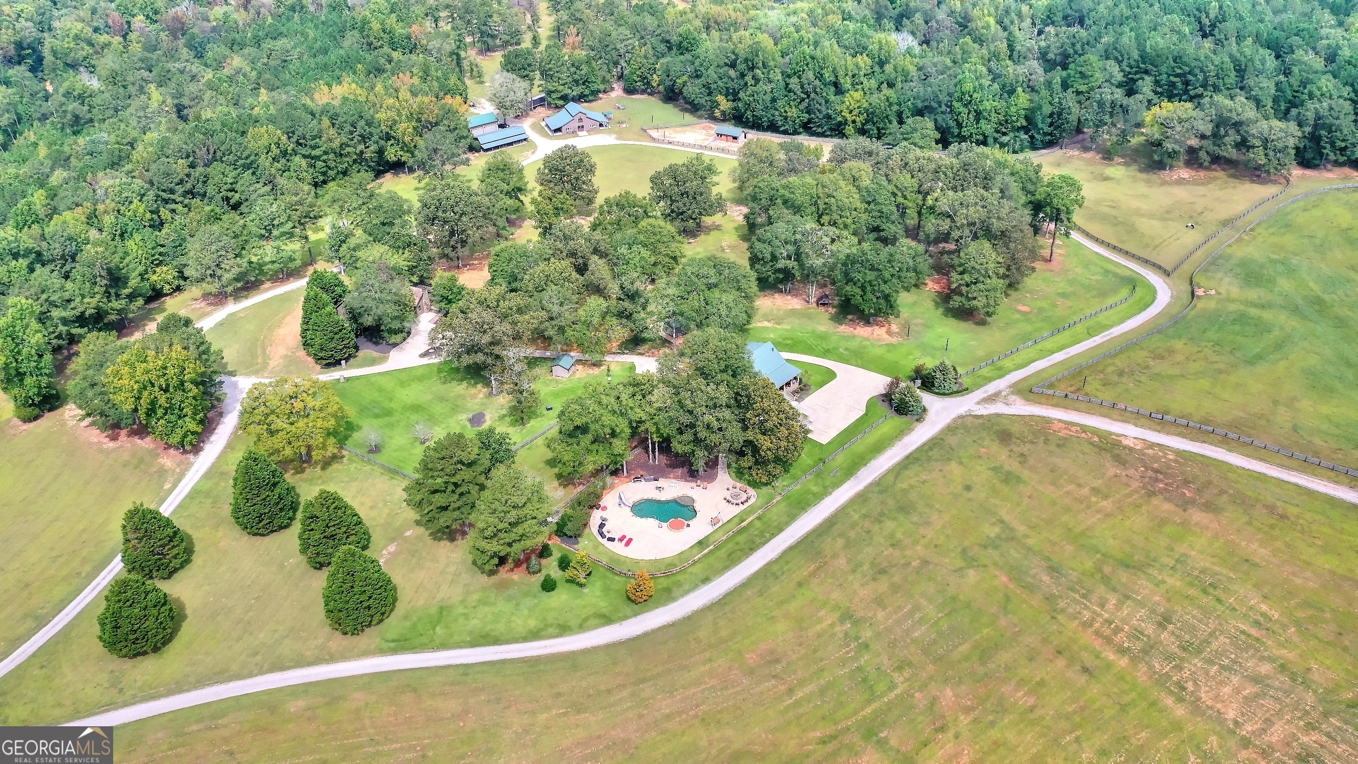 The Harris Farm (455.78 acres) is in north Morgan County on Mergendollar Road outside of the town of Bostwick. The farm is 12 miles to the town of Madison,14 miles to Watkinsville and 12 miles to Monroe.  The farm is one of the most beautiful in the area with rolling fields, mature hardwood forest and pine stands, a trophy bass lake, and several duck holes along the approximate 1.6 miles of frontage on Jacks Creek. Jacks Creek is a beautiful north Georgia rock-lined stream.  The improvements are extensive with a new custom 2 bedroom, 2 bath home and an older 3 bedroom 1.5 bath main home, multiple barns for horses and equipment.  The hunting is incomparable. Morgan County is renowned for big whitetails and has been a top-ten county for trophy whitetails for years. The duck hunting is reputed to be some of the best in the area with wood ducks and mallards using the beaver ponds and flying along Jacks Creek. Plenty of room for a dove field and releasing/raising quail.  The 9-acre pond is a well-managed trophy bass lake that has had double digit lbs. bass caught routinely. It has a new steel framed dock that will last indefinitely with good maintenance. Overall, a gorgeous lake to spend time with friends and family enjoying the clean water for swimming and fishing.  The horse barns and fenced paddocks are well set up for the equestrian. High quality materials and well-built barns for horses and tack are ready for the new owner. The trails for riding are extensive with varied beautiful views throughout the trail system.    A large power line will be constructed across the property in the next few years.  See documents for more details.