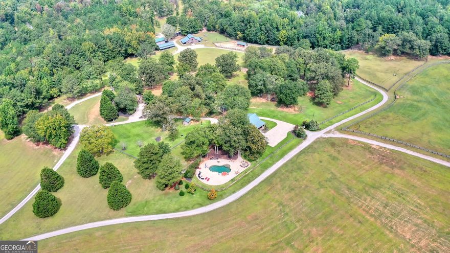 The Harris Farm (455.78 acres) is in north Morgan County on Mergendollar Road outside of the town of Bostwick. The farm is 12 miles to the town of Madison,14 miles to Watkinsville and 12 miles to Monroe.  The farm is one of the most beautiful in the area with rolling fields, mature hardwood forest and pine stands, a trophy bass lake, and several duck holes along the approximate 1.6 miles of frontage on Jacks Creek. Jacks Creek is a beautiful north Georgia rock-lined stream.  The improvements are extensive with a new custom 2 bedroom, 2 bath home and an older 3 bedroom 1.5 bath main home, multiple barns for horses and equipment.  The hunting is incomparable. Morgan County is renowned for big whitetails and has been a top-ten county for trophy whitetails for years. The duck hunting is reputed to be some of the best in the area with wood ducks and mallards using the beaver ponds and flying along Jacks Creek. Plenty of room for a dove field and releasing/raising quail.  The 9-acre pond is a well-managed trophy bass lake that has had double digit lbs. bass caught routinely. It has a new steel framed dock that will last indefinitely with good maintenance. Overall, a gorgeous lake to spend time with friends and family enjoying the clean water for swimming and fishing.  The horse barns and fenced paddocks are well set up for the equestrian. High quality materials and well-built barns for horses and tack are ready for the new owner. The trails for riding are extensive with varied beautiful views throughout the trail system.    A large power line will be constructed across the property in the next few years.  See documents for more details.