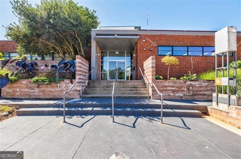 Introducing this wonderful 2 level, contemporary industrial loft near the Pullman Yards area of Edgewood Atlanta. Located in sought after Arizona Lofts, this well maintained property features an open concept floor plan with tons of natural light and a secure, tranquil setting. Open air courtyards and walkways give this property a unique and vibrant feel. Enjoy coffee or drinks on your oversized private patio. The outdoor space is also great for pets, gardening or dining al fresco. As you enter the home you'll notice the soaring 25' ceilings, a wall of windows, sealed concrete floors, granite countertops in the kitchen along with a stainless steel appliance package. The main floor is an open concept layout with room for a dining area, living area and kitchen. The kitchen has white cabinets, plenty of counter space and views to the living and dining areas. The main floor also features a half bath, laundry room and walk-in pantry. The second floor loft includes the owner's primary bedroom with en-suite bathroom, large walk-in closet and linen closet. The bathroom features a large single vanity with plenty of storage space, walk-in tiled shower and walk-in closet. Amenities include a club room, renovated fitness room, bicycle racks, 2 saltwater pools, dog park, controlled access parking and building, lush landscaping and recent exterior updates. Convenient to Kirkwood, Edgewood, Decatur, L5P and downtown, Arizona Lofts is also a short 1/3 mile to the Edgewood-Candler Park MARTA station. This home has it all--Convenient location, fantastic amenities and wonderful square footage and layout. Welcome home!