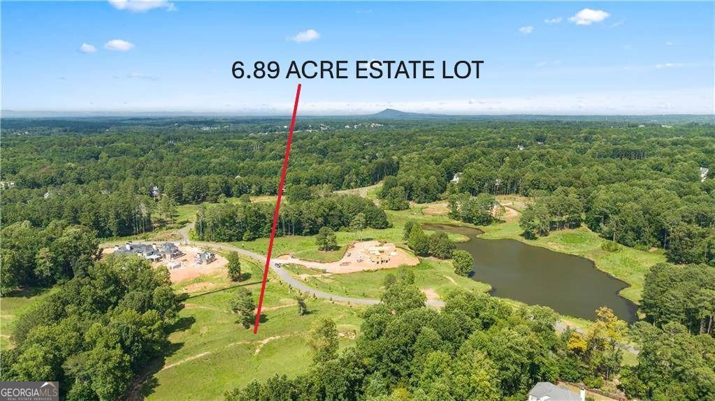 This Incredible 6.89 Acre Private (Former Trophy Club Golf Course) Now New Estate Lot with Beautiful Lake and Tree Lined Views is now available and waiting for your new estate site and future custom luxury home in the Prestigious Exclusive Gated Community The Homestead at Milton in the Heart of Milton near plentiful shopping, delicious dining, top rated schools (pubic & private), great entertainment, sports fields, parks and so much more! There is no other lot quite like this one that offers it all from the expansive build area to the privacy of tree lined buffers and stunning views with amazing completed and near completion estate homes in the community already. You can finally have your dream estate in an established community and build with a collection of pre-approved nationally acclaimed award winning building and architectural teams already in the community or submit your own for approval. Community HOA and Architectural Controls ensure the aesthetics, beauty and completion standards of the community and the gated entry ensures privacy in this former meticulously maintained golf course converted into amazing homesites for stellar custom homes like yours. There is no place like home when you build here on this perfect for you Lot 27 home site allowing room for everything from one home to a large estate with room for pool house, guest house, sports courts, plentiful outdoor living, poolside paradise space, nature lovers dreams with mature hardwood trees, existing top luxury estate new homes in the community and only minutes to Avalon, GA400, Downtown Alpharetta with easy commutes as well. This rare find offers the best of it all and something for everyone with plentiful privacy, stunning views, room to roam, play, entertain, relax, and live the lifestyle you deserve! Enjoy the ability to lock and leave in this private gated preserve while enjoying true resort style living on your own once in a lifetime estate lot and custom home opportunity here on Homesite 27 in The Homestead at Milton. Only a few opportunities remain so hurry! Call for for availability, appointment and access.