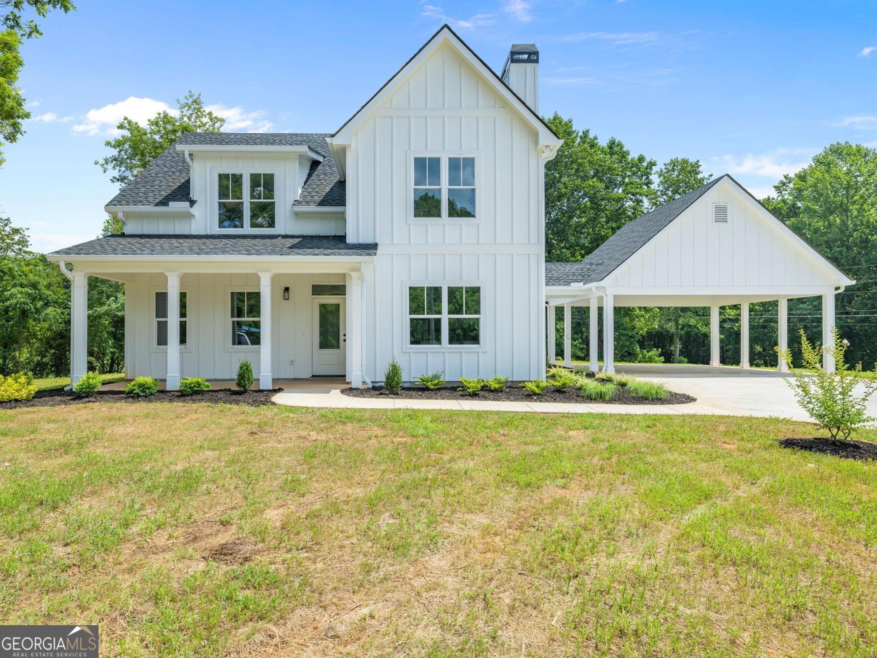 Spacious 1.873 acre corner lot in Mt. Airy, this new construction Modern Farmhouse offers the perfect blend of style, comfort, and convenience. With easy access to Hwy 365 and no HOA or subdivision restrictions, the home provides both privacy and freedom. The level yard is beautifully complemented by a stunning oak tree in the side yard, creating a serene setting. Inside, the open-concept kitchen flows seamlessly into the living and dining areas, while a convenient laundry room is accessible from both the master bathroom and kitchen. With four bedrooms and three full bathrooms, plus a half bath, this home is designed for modern living. Enjoy outdoor relaxation on the covered back patio, or take advantage of the two-car carport for added storage. Built with efficiency in mind, this home features spray foam insulation in the roofline and walls, ensuring low maintenance and optimal comfort throughout the year.