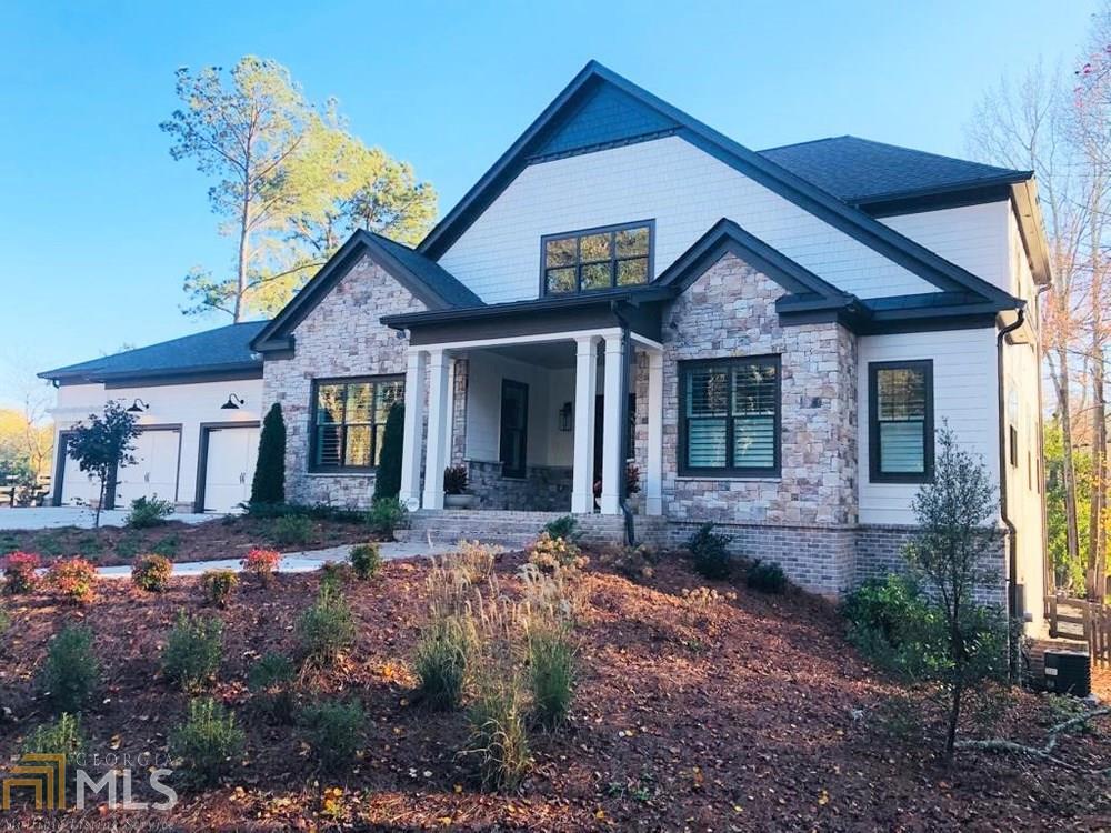 Truly exceptional Estate with Galore Features, Architectural Details, Exquisite Curb Appeal, on an acre lot, just minutes to Downtown Roswell. Strategically located, ideal to walk to Canton Street for restaurants and shopping, on sidewalks, and minutes drive to 400. As you step in the graciously enclosed Front Porch, and open the Jennifer Glassworks Double Front Door, you can look through the house to the nature beyond! Get ready to fall in love with this Light filled home with beautiful architecture, Rich Hardwood Flooring, Specialty Ceiling Treatments, Tasteful Light Fixtures, Quartz countertops. It features a Master on Main, Guest Suite on Main, Huge Office and 2 Secondary Bedrooms Upstairs plus room for a third one (framed with stubbed bath and window), a Full Daylight Terrace (with more space to finish as well), a lush level backyard, etc. A total of 4 Bedrooms, 4 Full Baths, 4 Half Baths, & 3 Fireplaces! Stellar Gourmet Kitchen features Quartz for both countertops & backsplash, Large Island with additional cabinets, a secondary prep sink, wine cooler, large Walk-in Pantry and Spacious Butler Pantry with fridge and cabinets for extensive storage. Huge Dining Room with Wainscot and Plantation Shutter. The Family Room with its Coffered Ceiling, Bookcases & Linear Fireplace, leads you to the Screened Deck with its own Fireplace overlooking the manicured landscaped yard and the lake. As you go down the Partially Finished Daylight Terrace, you are greeted by a cozy Bricked Wine Cellar, 2 Entertainment Rooms with exterior access to the patio, and walk to the fire pit area next to the enjoyable pond and the lush landscaping. The 3 Car Garage features Counters with Cabinets and a Sink, to wash your dog or appliances. Make your dreams come true, now.