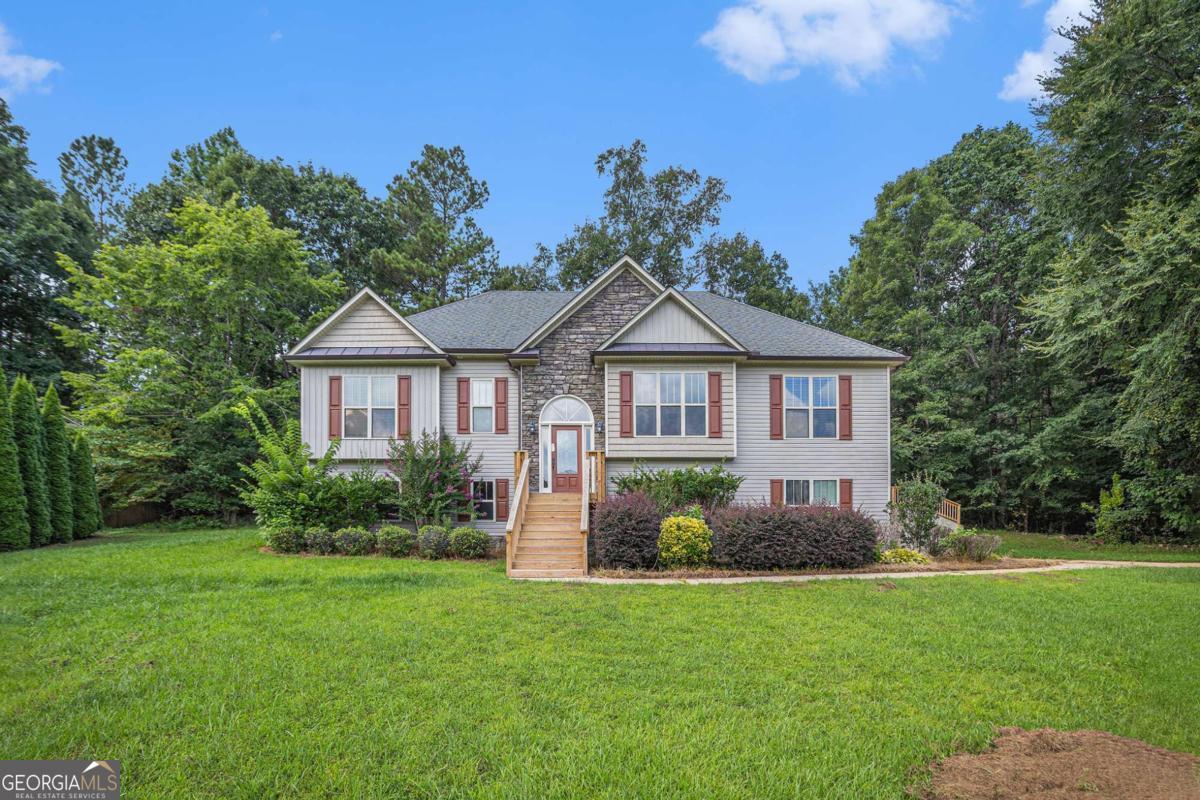 Located in the highly sought-after North Paulding school district, this spacious 3-bedroom, 3-bath home offers a versatile layout perfect for today's lifestyle. The split-bedroom floor plan provides added privacy, while the large family room features soaring ceilings and a cozy fireplace, ideal for relaxing or entertaining. The open-concept dining room flows seamlessly into the eat-in kitchen, which includes a pantry and solid surface countertops. The oversized primary suite boasts two walk-in closets, a dual vanity, separate shower, and a soaking tub for ultimate comfort. The finished basement offers incredible flexibility, with two additional rooms and a full bath - perfect for a teen or in-law suite, home office, or media space. Enjoy outdoor living on the back deck and take advantage of the 3-car garage with ample storage.