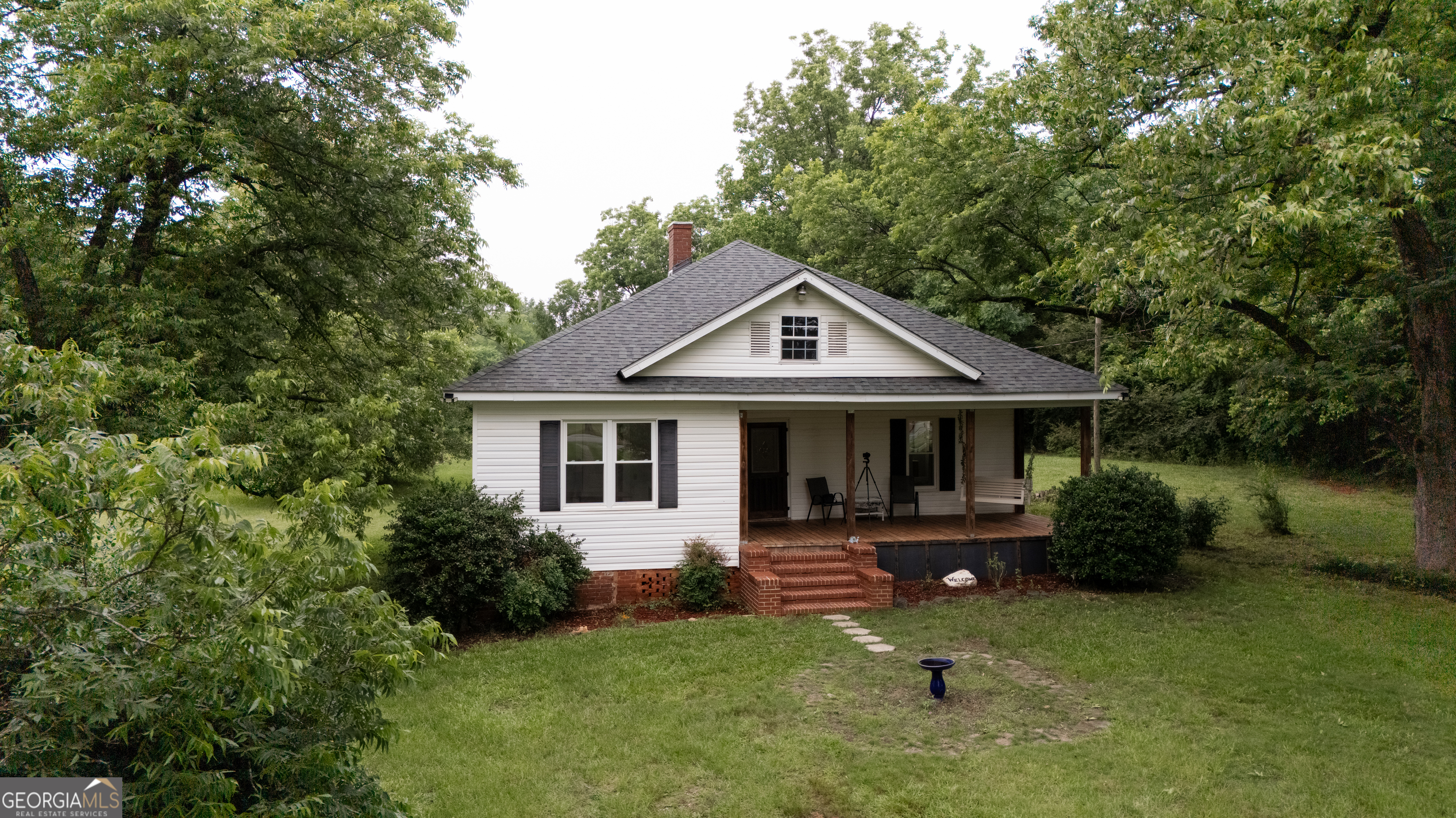 Charming 1928 Farmhouse with Modern Upgrades and Spacious Land Step back in time with this beautifully maintained 1928 farmhouse, offering the perfect balance of historic charm and modern conveniences. Located on a generous 2-acre lot, this 3-bedroom, 2-bath home boasts 1,755 square feet of living space, and is just minutes away from downtown Forsyth and I-75, making it an ideal location for those seeking both tranquility and accessibility. Upon entering, you'll be greeted by the warmth of original hardwood floors, freshly refinished in 2023 to bring out their natural beauty. The spacious living areas flow seamlessly, providing a welcoming atmosphere perfect for both everyday living and entertaining. The home maintains its classic farmhouse feel, with thoughtful updates to enhance comfort and efficiency. Each of the three bedrooms offers generous space, and the two full bathrooms have been designed to blend the farmhouse style with modern amenities. Recent upgrades ensure this home is move-in ready, including a brand-new roof, A/C unit, windows, and tankless water heater-all installed in 2023, enhancing the home's energy efficiency and also offering views of the sprawling yard and surrounding nature. Whether you're relaxing on the front porch, gardening in the backyard, or enjoying the peace of country living, this property offers plenty of space to roam and unwind. The expansive 2-acre lot provides room for a garden, outdoor entertaining, or even future expansion. With its great location just minutes from downtown Forsyth and easy access to I-75, this farmhouse offers the perfect blend of rural charm and convenience. Don't miss the chance to make this charming home yours. Schedule a showing today and experience the best of both worlds!
