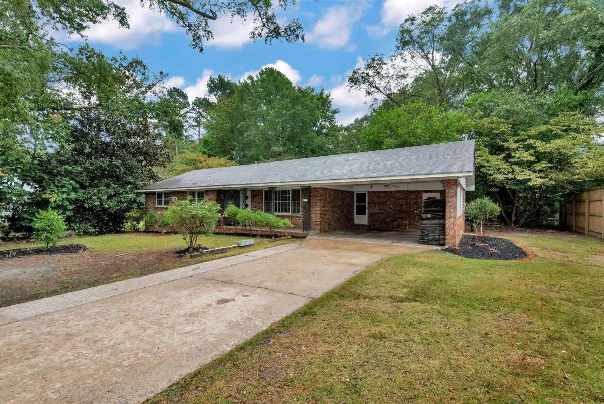 Attention investors! Are you looking for Big Money making flip or the perfect rental. This 4 sided brick home with original hard wood floors has over $100,000.00 in equity! Comparable sales after rehab show this house will sell for $300,000.00+ or rent for 2,000 per month. The 2 car open carport can easily be finished into additional living space or close into a garage. There are also 3 detached buildings in the very private back yard with 100 year oak trees. City water and sewer working and running great. Home currently has no power. Don't let this deal pass you buy!