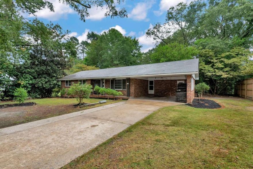 Attention investors! Are you looking for Big Money making flip or the perfect rental. This 4 sided brick home with original hard wood floors has over $100,000.00 in equity! Comparable sales after rehab show this house will sell for $300,000.00+ or rent for 2,000 per month. The 2 car open carport can easily be finished into additional living space or close into a garage. There are also 3 detached buildings in the very private back yard with 100 year oak trees. City water and sewer working and running great. Home currently has no power. Don't let this deal pass you buy!