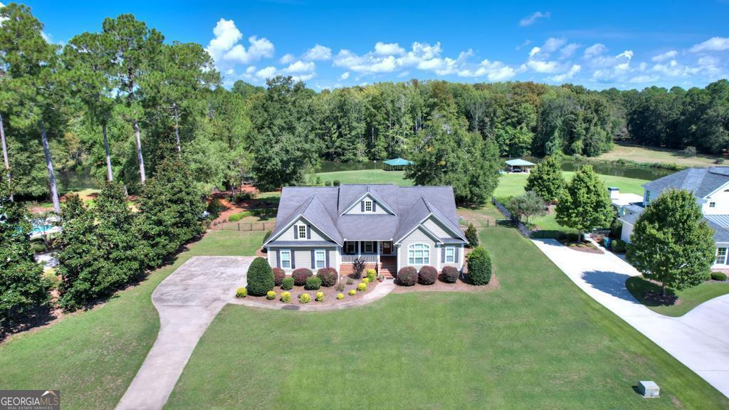 This stunning home offers quality that is not seen every day! Custom built in 2008 beauty is located out of the floor plain, and still looks brand new inside and out!!!The interior features a large living room with a fireplace and built-ins, a MASSIVE kitchen with dining, beautiful hardwood floors throughout the home, a spacious master suite with spa, and up to an additional four bedrooms (if desired), plus two more full baths. Just outside you will find a pretty front porch, a screened porch and a covered porch with a concrete patio. At the water's edge, there is a double boathouse and a concrete seawall. If the quality of your home and its' location is at the top of your list, this one is MOST definitely a MUST SEE!!! AND THIS HOME IS ALL ONE LEVEL ON A LEVEL LAKE LOT!!!