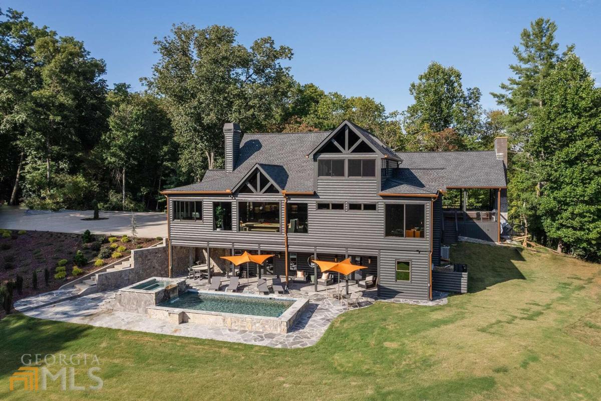 Contemporary rustic compound w/ 60 +/- acres and adjoining National Forest w/ modern luxuries and mountain simplicities - welcome to "Zanga 4.0!" Stunning 4,200 +/- sq. ft. main house is complete with four bedroom suites, two additional bunk rooms, large office overlooking lush meadow, and gorgeous carrera marble bathrooms. Sleek accents combine with painted tongue and groove walls and ceilings, rough sawn cabinetry, and walls of glass to create the perfect blend of modern and rustic finishes. Main level living room is centered around large stone F/P, gourmet kitchen, butler's pantry and stunning eat-in island. Off the main, find an 1,110 sq. ft. bespoke party porch w/ 24' rooflines, large masonry F/P, and gourmet outdoor kitchen. Terrace level den opens up to large stone patio and heated pool w/ jacuzzi overlooking lush meadow, stocked pond, and complete privacy. Full entertainer's bar is accessed from pool deck w/ full drink cooler and pool house kitchen. At top of prop., find an original hunter's blind turned outdoor party pavilion with 180 degree mountain views, massive fire pit, and half bath. Also includes an unfinished 4,000 sq. ft. barn w/ power and plumbing, two small pole barns, and a three bay car barn. Fully gated, equipped w/ a whole house generator and with a roaring creek that runs throughout the property and with numerous potential home sites, this would make for the perfect mountain retreat, investor's project, or rental investment!