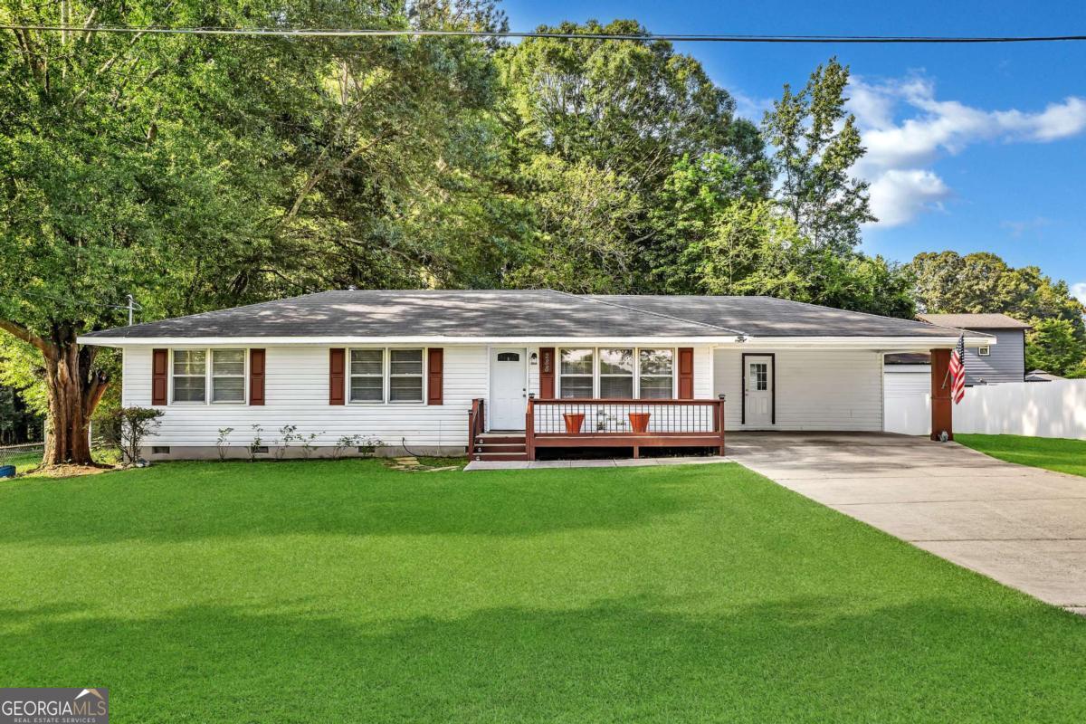 Charming Ranch Home with Expansive Workshop & An AMAZING LOT! Don't miss this well-maintained 3-bedroom, 2-bath ranch offering spacious 1,248 sq ft of comfortable living. Step inside to find updated flooring throughout, a spacious living room filled with natural light, and a large open kitchen featuring that is perfect for gatherings. This home has been meticulously maintained over the year with many custom updates and upgrades. The home's thoughtful layout includes a generous primary bedroom, two additional bedrooms, and a convenient laundry area. Outside, you'll love the clean and functional detached workshop with multiple roll-up doors-ideal for storage, hobbies, or a home business. Enjoy privacy every day in the fenced backyard which backs up to mature trees for a peaceful retreat! Located close to shopping, dining, and everyday conveniences, this property offers space, flexibility, and incredible value!