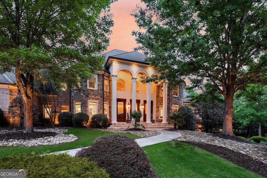 Tucked inside The Paddocks, a quiet enclave of luxury estates, 110 Ryan Lake Trail is a privately gated lakefront residence offering over 14,000 square feet of refined living space on 3.8 acres in Alpharetta-perfectly positioned on the Cherokee County side for the benefit of lower property taxes while remaining close to all that Milton and Alpharetta have to offer. Designed for both grand entertaining and comfortable everyday living, this impressive privately gated residence features six bedrooms plus a large flex room currently used as a seventh bedroom, seven full bathrooms, three half bathrooms, and a total of six garage spaces. The home's well-planned interior layout includes expansive living areas across all three levels, multiple bedroom suites, and a thoughtful blend of formal and casual spaces to suit a variety of lifestyles. A grand two-story foyer with a timeless wrought-iron curved staircase opens to a spacious great room with soaring ceilings and a fireplace, creating a central gathering space for the home. The kitchen is designed for entertaining, with a large center island, Thermador and SubZero appliances, walk-in pantry, and a separate catering kitchen with private garage access-ideal for hosting events or large parties. The layout flows into a fireside keeping room and breakfast area, as well as a summer kitchen and living space with vaulted tongue-and-groove ceiling, grilling station, and dual dishwashers for convenient indoor-outdoor living.  The main-level primary suite offers a private retreat with a morning bar, fireside sitting area, private balcony, spa-inspired bathroom, and an oversized custom walk-in closet with central island. The main level also includes a formal study, formal dining room, mudroom with built-ins, two guest powder rooms, and sizable laundry room. Upstairs, a second primary suite with Juliet balcony is accompanied by two additional ensuite bedrooms, a fourth bedroom with hall bath, secondary laundry room, and a large bonus room that can serve as a playroom, media room, or seventh bedroom. The finished terrace level is designed for recreation and relaxation, featuring a home theater, game room, sauna, custom fitness gym and golf simulator, full bar, wine cellar, guest ensuite, and an additional bathroom. It opens directly to the backyard and the property's private lake frontage, offering a peaceful setting for quiet outdoor enjoyment. Additional highlights include a whole-home audio system, Vantage lighting controls, LeafGuard gutters, and a dedicated sump system. The grounds are professionally landscaped and include a full sprinkler system and outdoor lighting throughout. With four garages on the main level and two on the terrace level, the property is well-suited for car collectors, multigenerational living, or extra storage. The private lake offers a unique and serene outdoor amenity for non-motorized recreation or simply enjoying nature. Zoned for sought-after Creekview High School and minutes from top local attractions, the home is just 5 minutes to Milton's Mini Publix, 7 Acre Barn Grill, and Scottsdale Farms, 15 minutes to the shops and restaurants of Downtown Crabapple, and 20 minutes to GA-400, Avalon, and Halcyon. Additional 3 acres available for $650,000