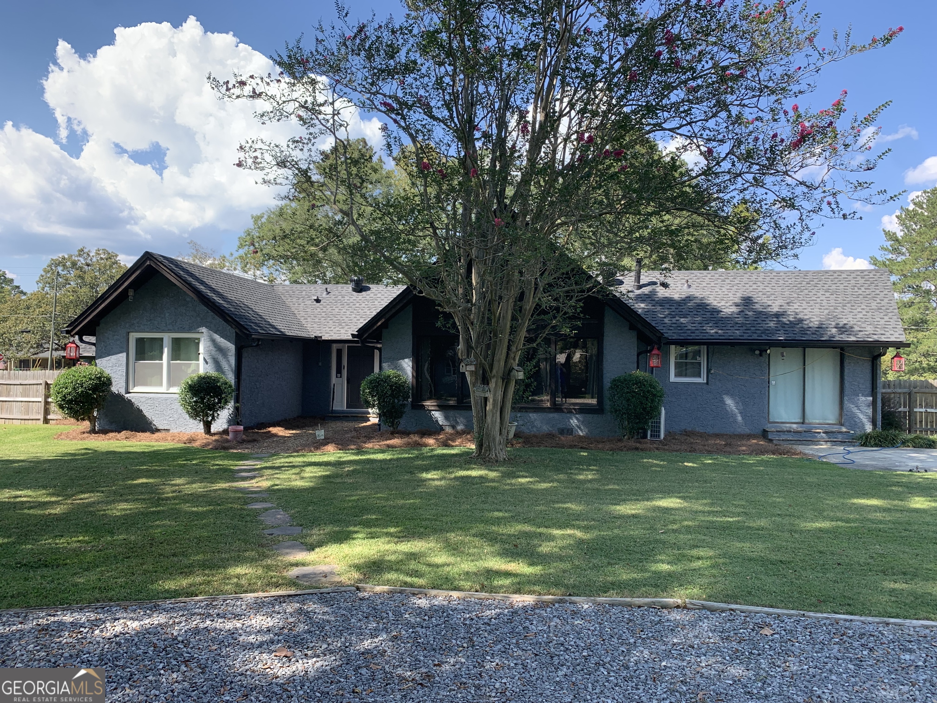 Discover the perfect blend of privacy and convenience with this unique property just minutes from downtown. Nestled on a spacious 2.7-acre lot, this beautiful country style home offers room to breathe, space to grow, and a lifestyle that balances city access with peaceful living. Step inside to a warm and inviting living area featuring a large, open fireplace-perfect for cozy nights and entertaining guests. Abundant natural sunlight fills the home, enhancing its open and airy feel. Outdoors, you'll find a large, gated backyard ideal for pets, play, or hosting gatherings with plenty of parking. You will also find a functioning well for those looking to garden or just have extra water source. The property also includes a huge shop with power, perfect for hobbies, projects, or a home business. Need even more storage? You're covered with a 400 sq. ft. outbuilding with power and a 20x30 dedicated RV awning-great for protecting your RV, boat, or extra vehicles. Call today because this one is unique and will not last long.